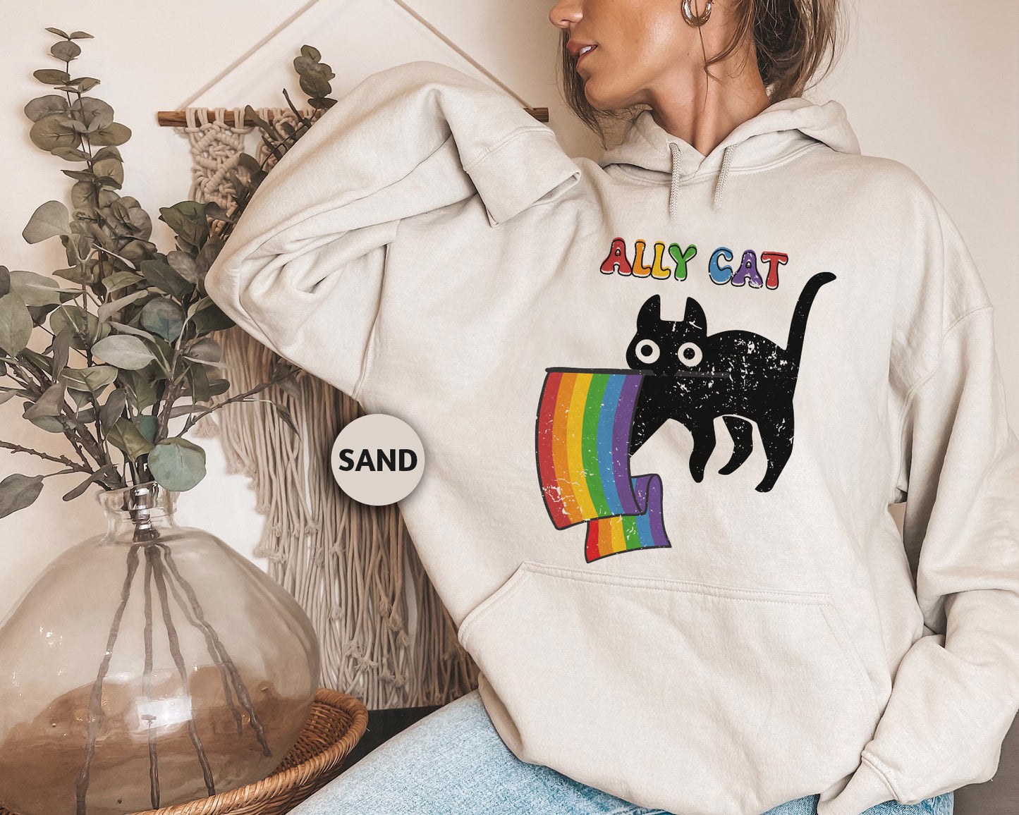 a woman wearing a white hoodie with a black cat on it