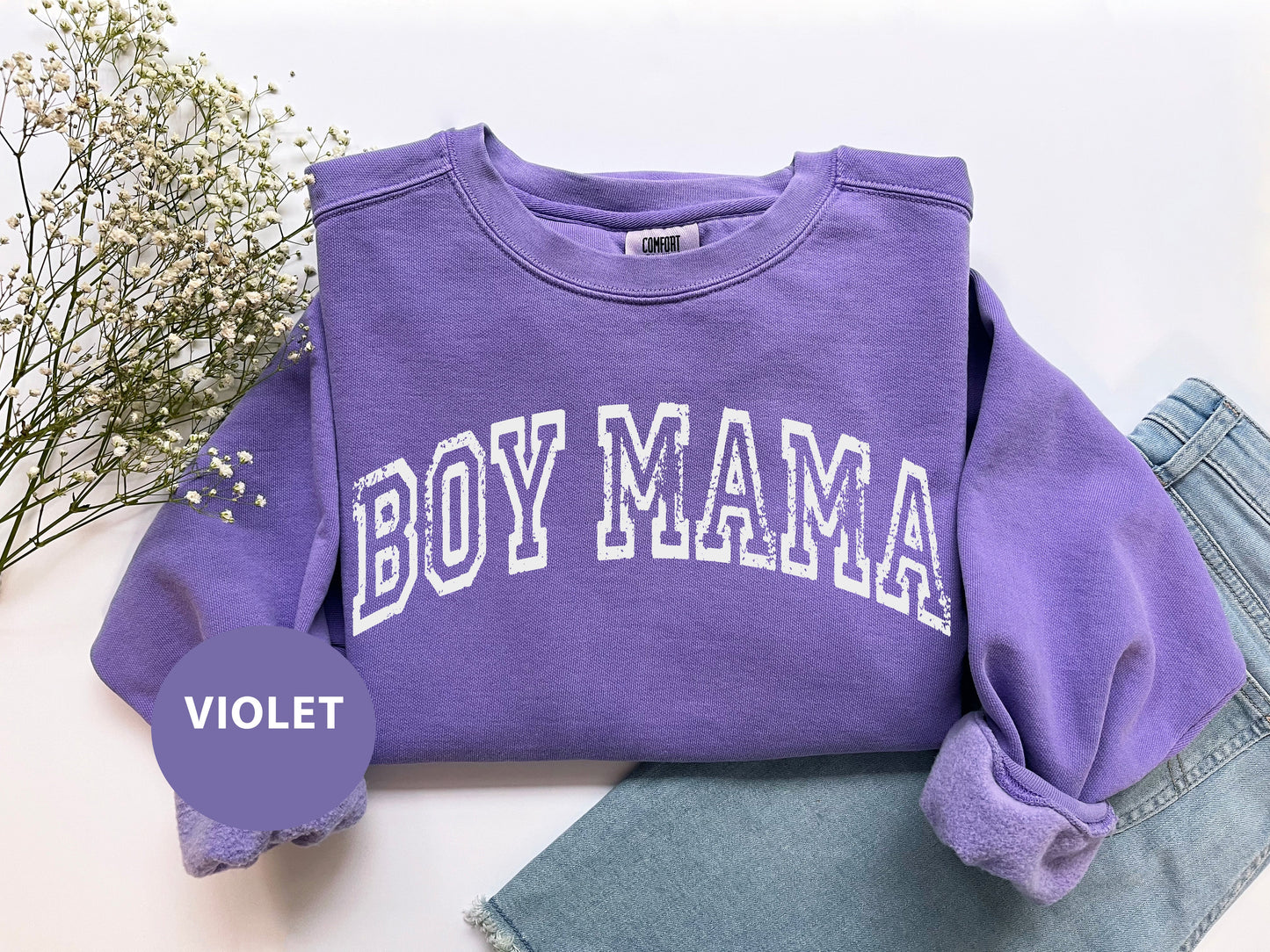 a purple sweatshirt with the word boy mama on it