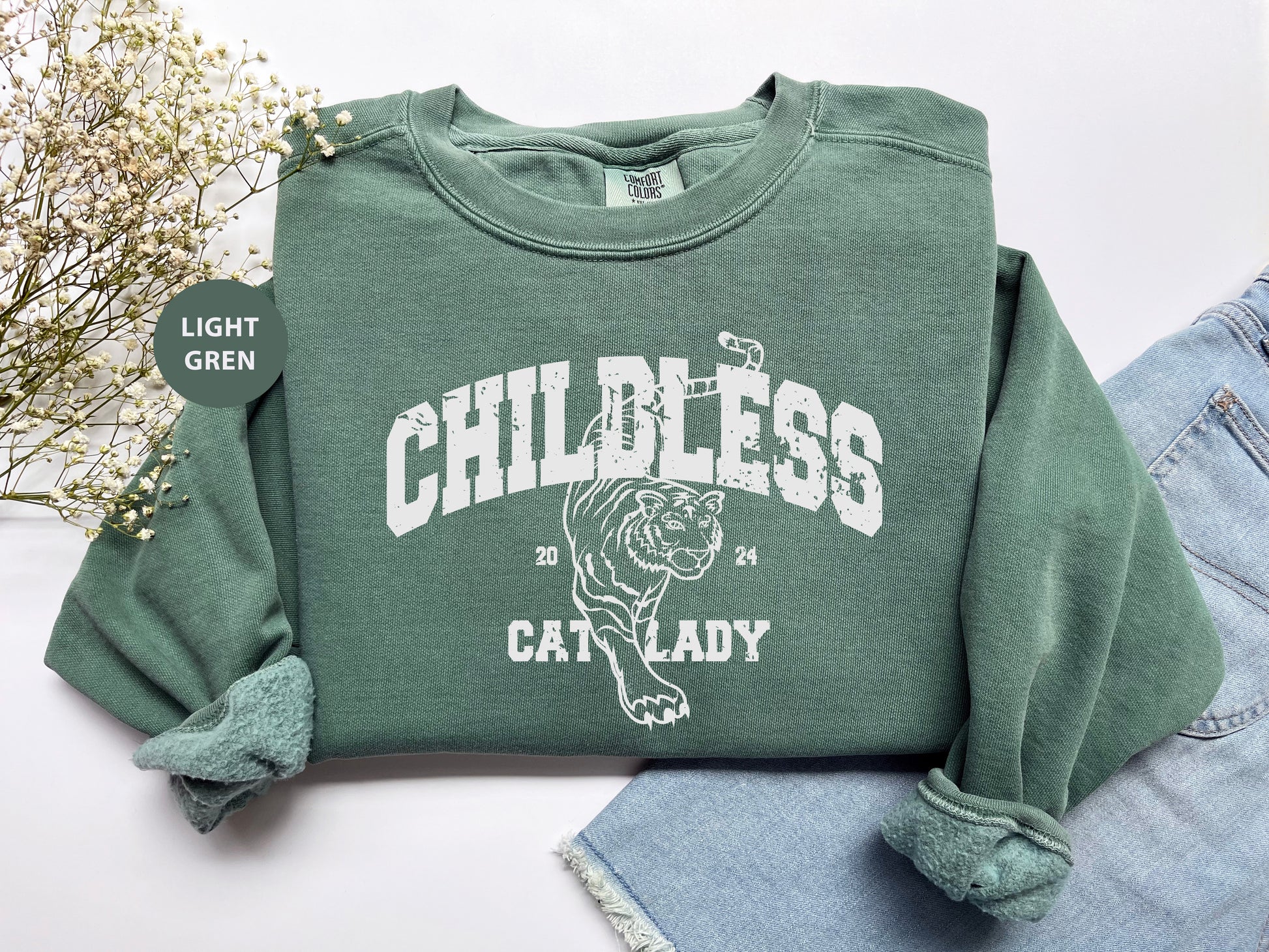 a green sweatshirt with a cat lady on it