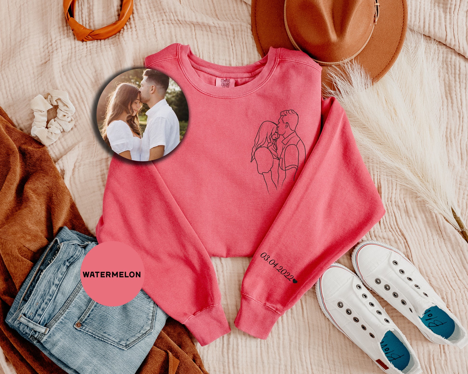 a pink sweater with a picture of a man and a woman on it