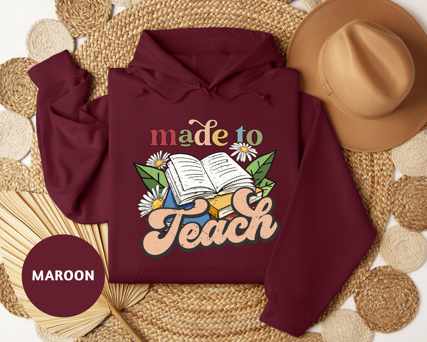 a maroon hoodie with the words made to teach on it