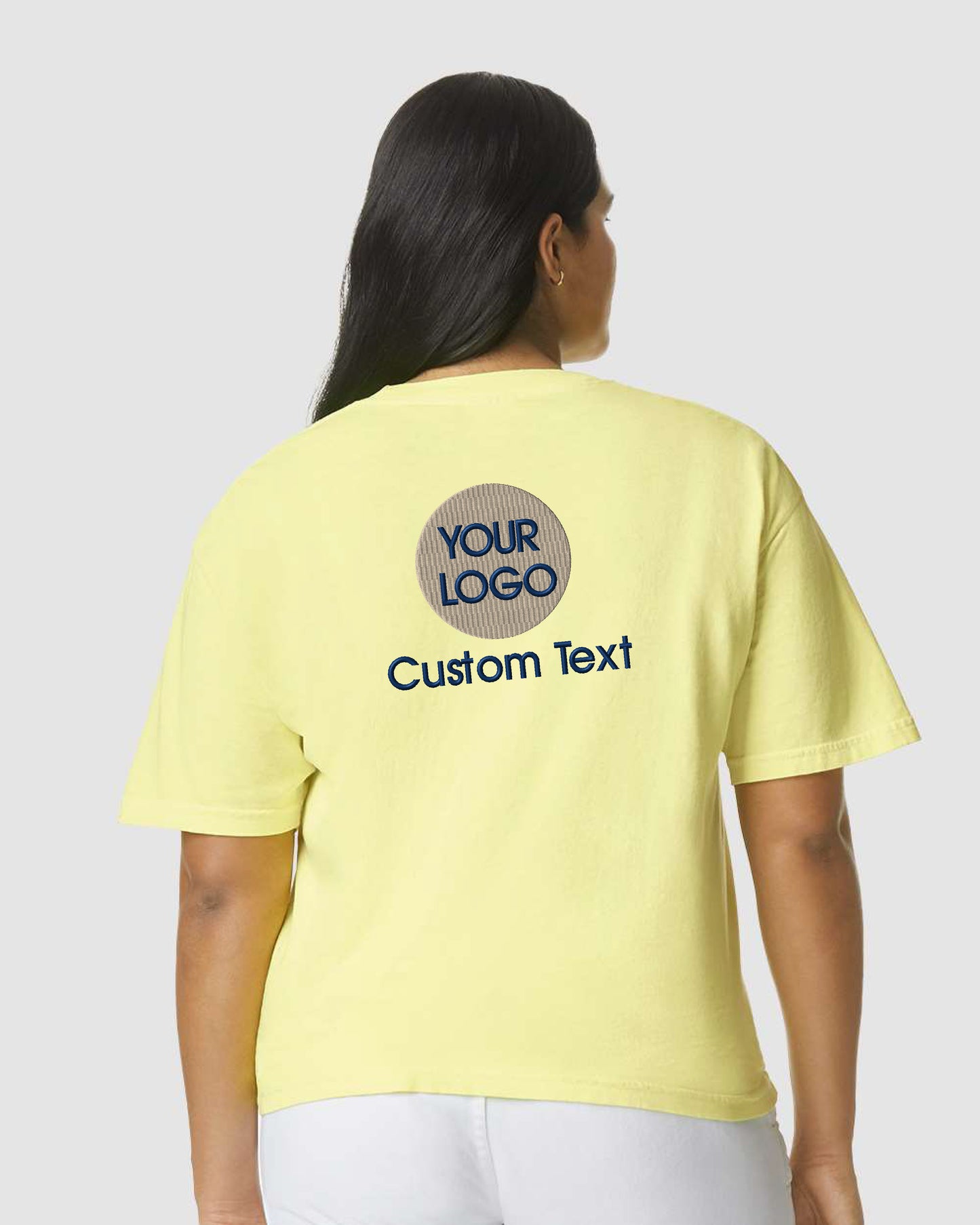 a woman wearing a yellow t - shirt that says your logo