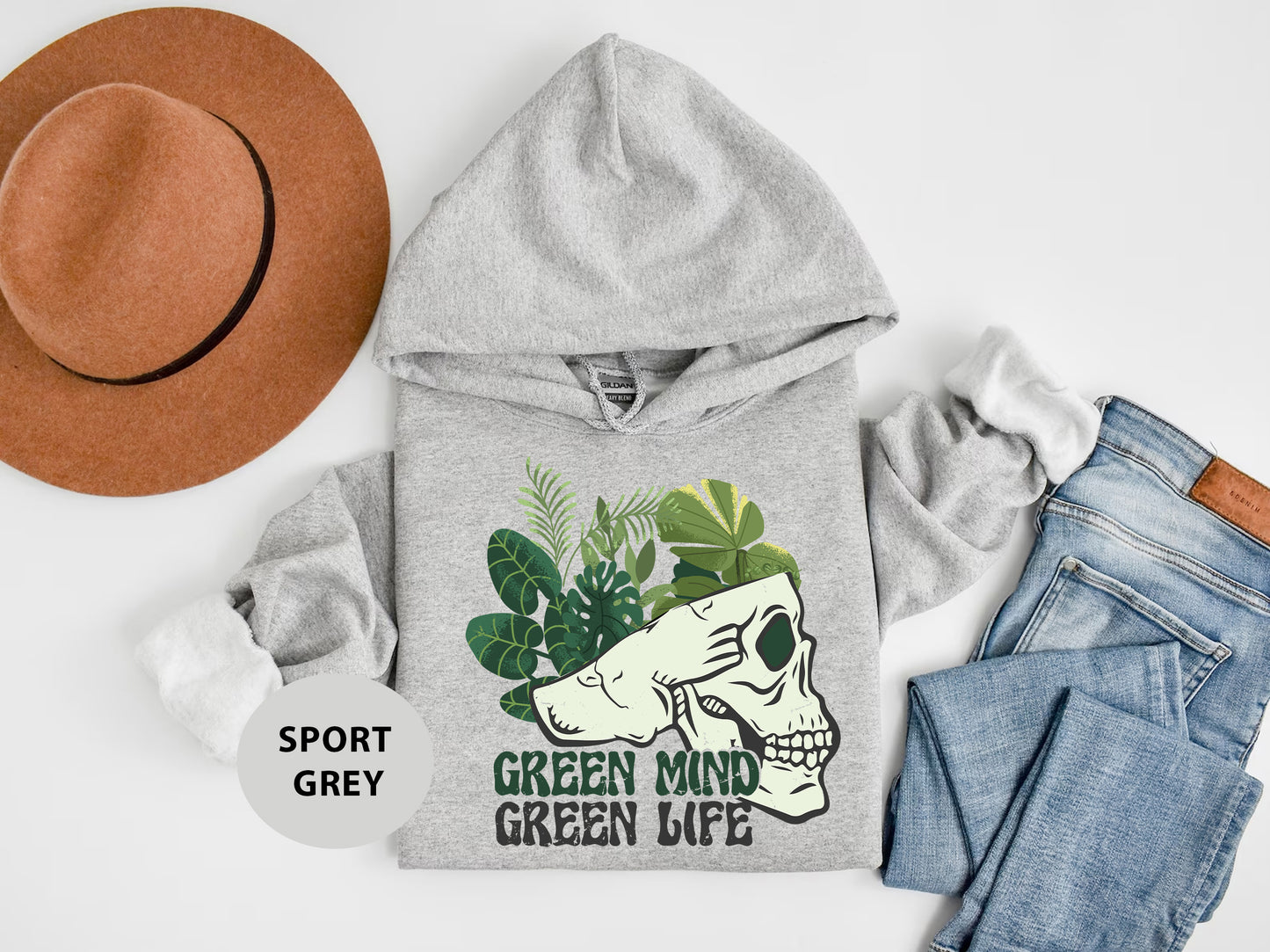 a gray hoodie with a green mind on it next to jeans and a hat