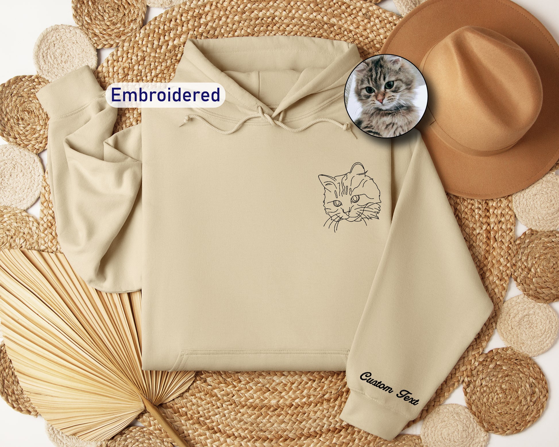 a cat is sitting on top of a hoodie