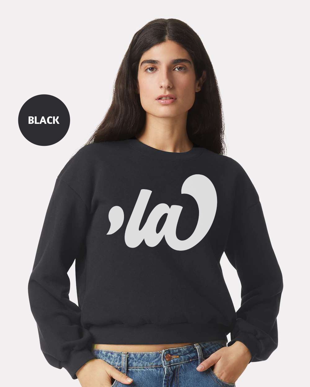 a woman wearing a black sweatshirt with the word la on it