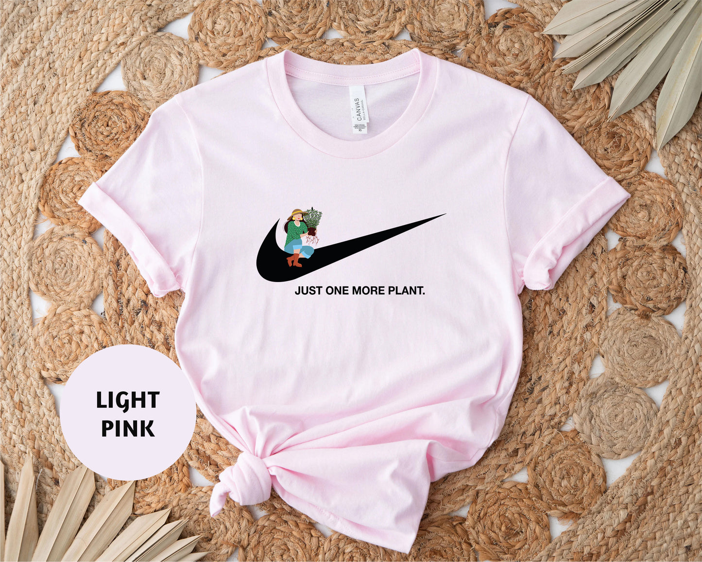 a pink shirt with a black nike logo on it