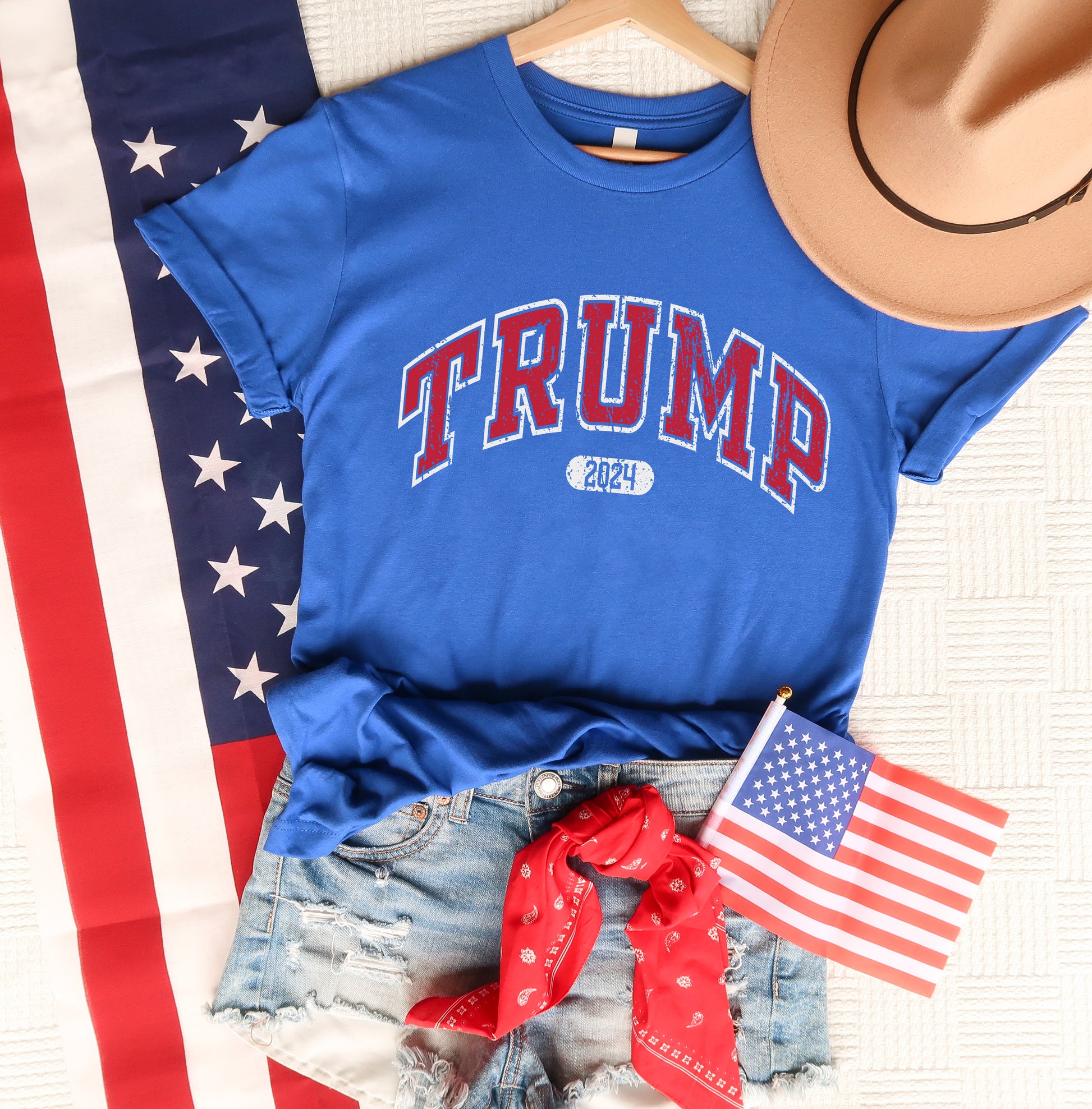 a blue shirt with the word trump on it and an american flag