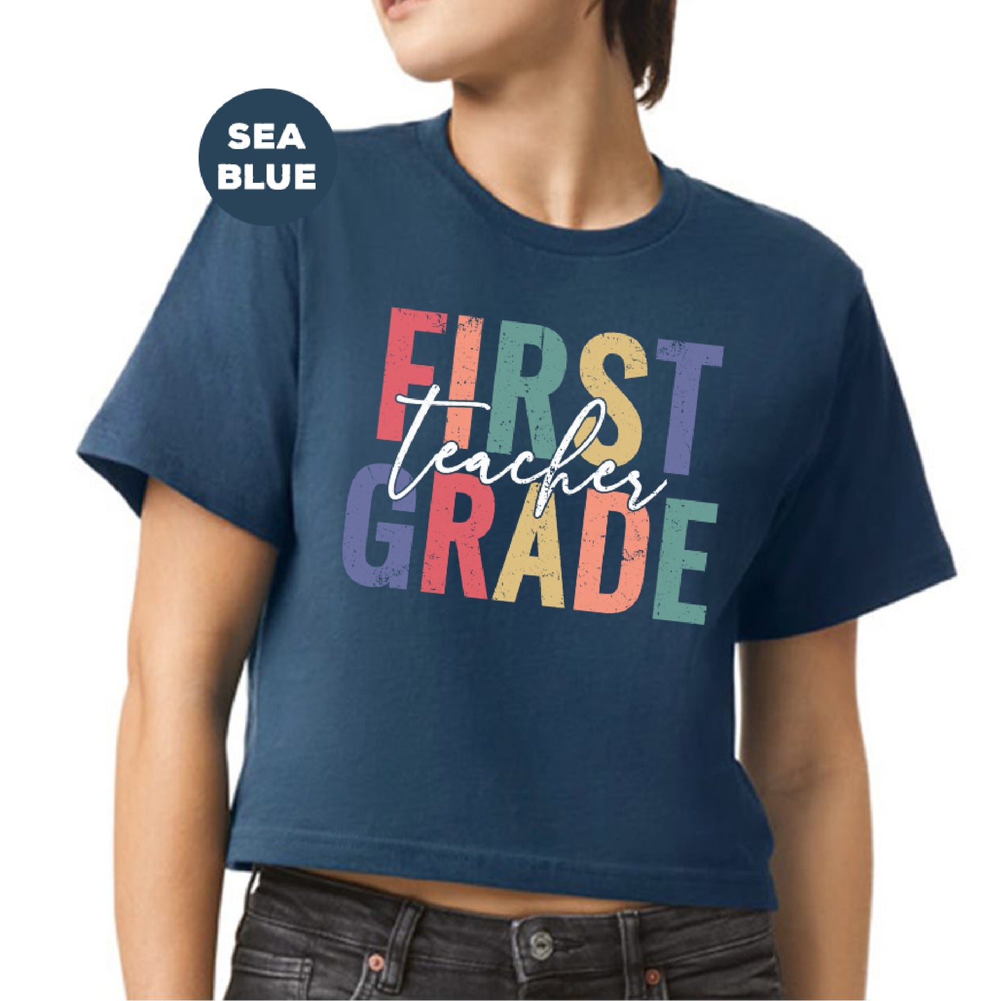 a woman wearing a blue shirt that says first grade