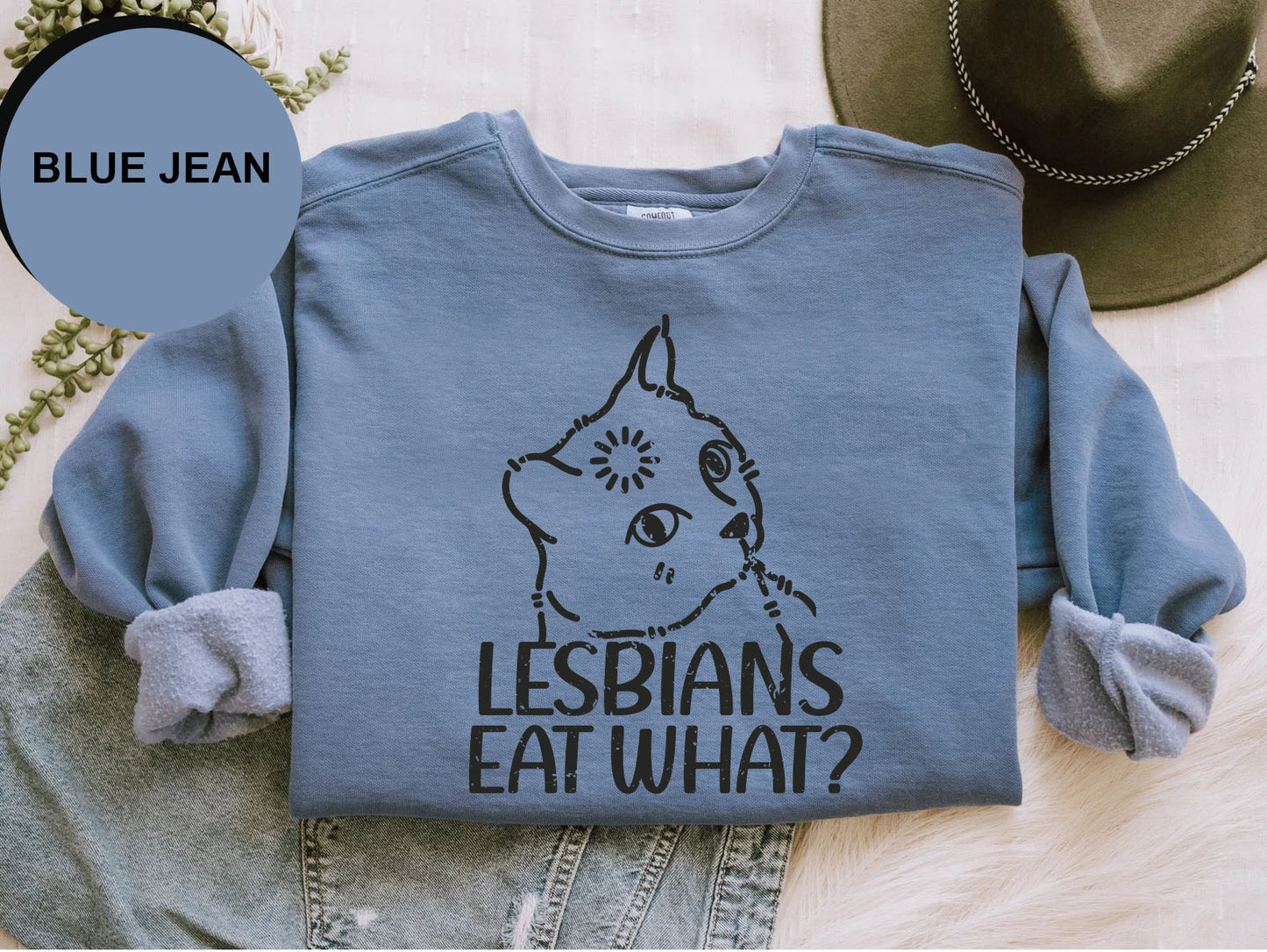 a blue jean shirt with the words lesbians eat what? on it