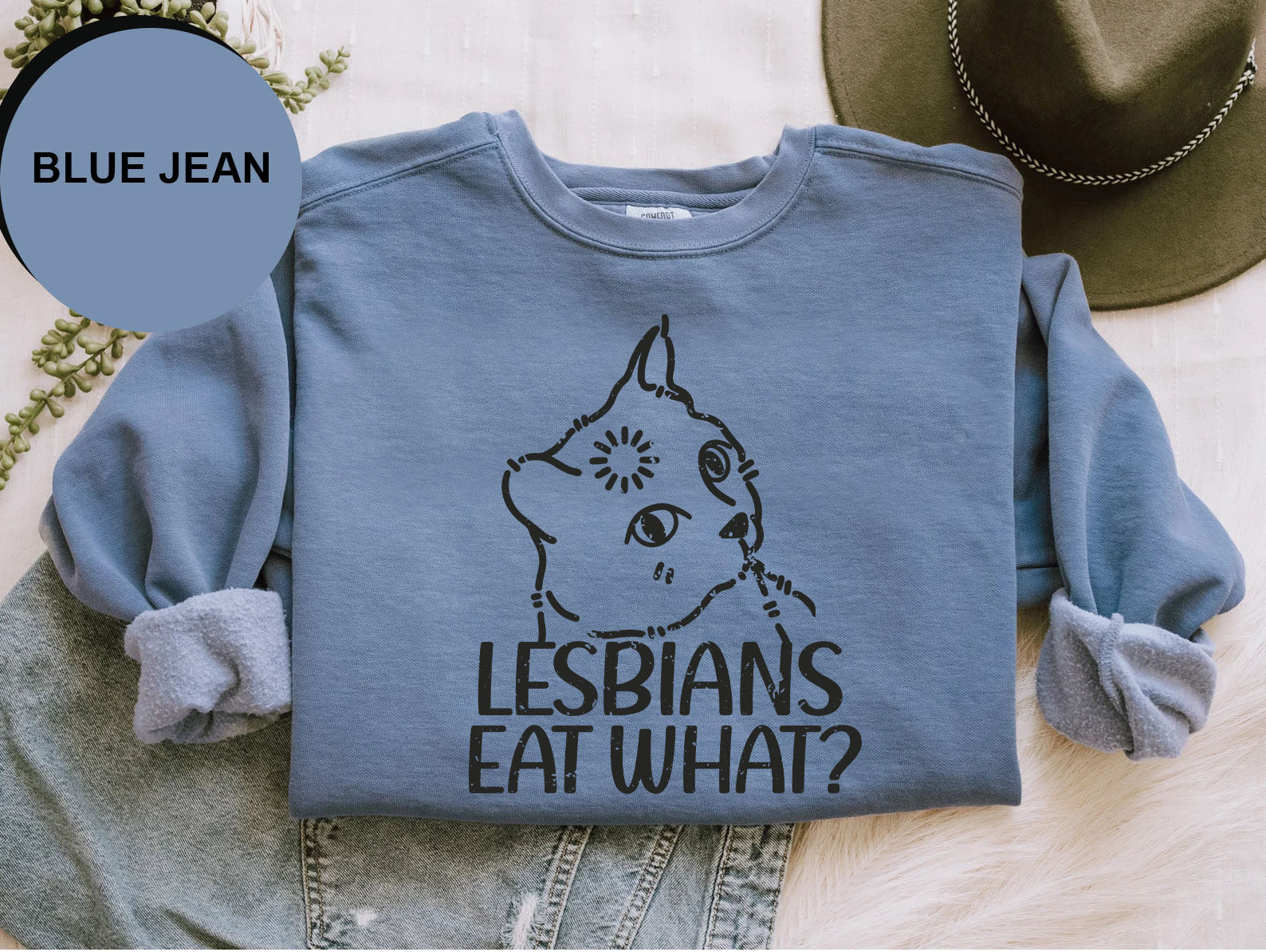 a blue jean shirt with the words lesbians eat what? on it