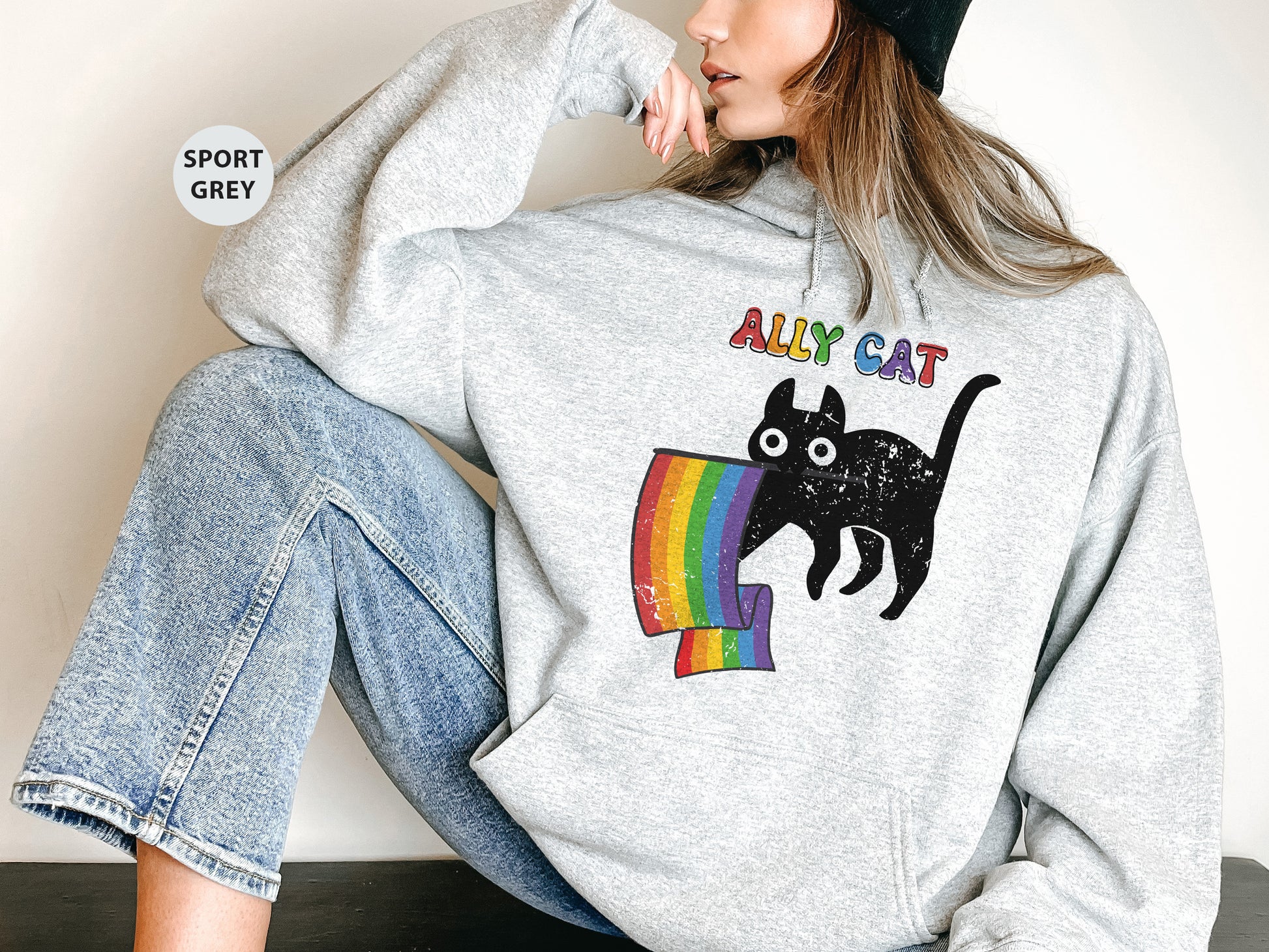 a woman wearing a sweatshirt with a cat on it