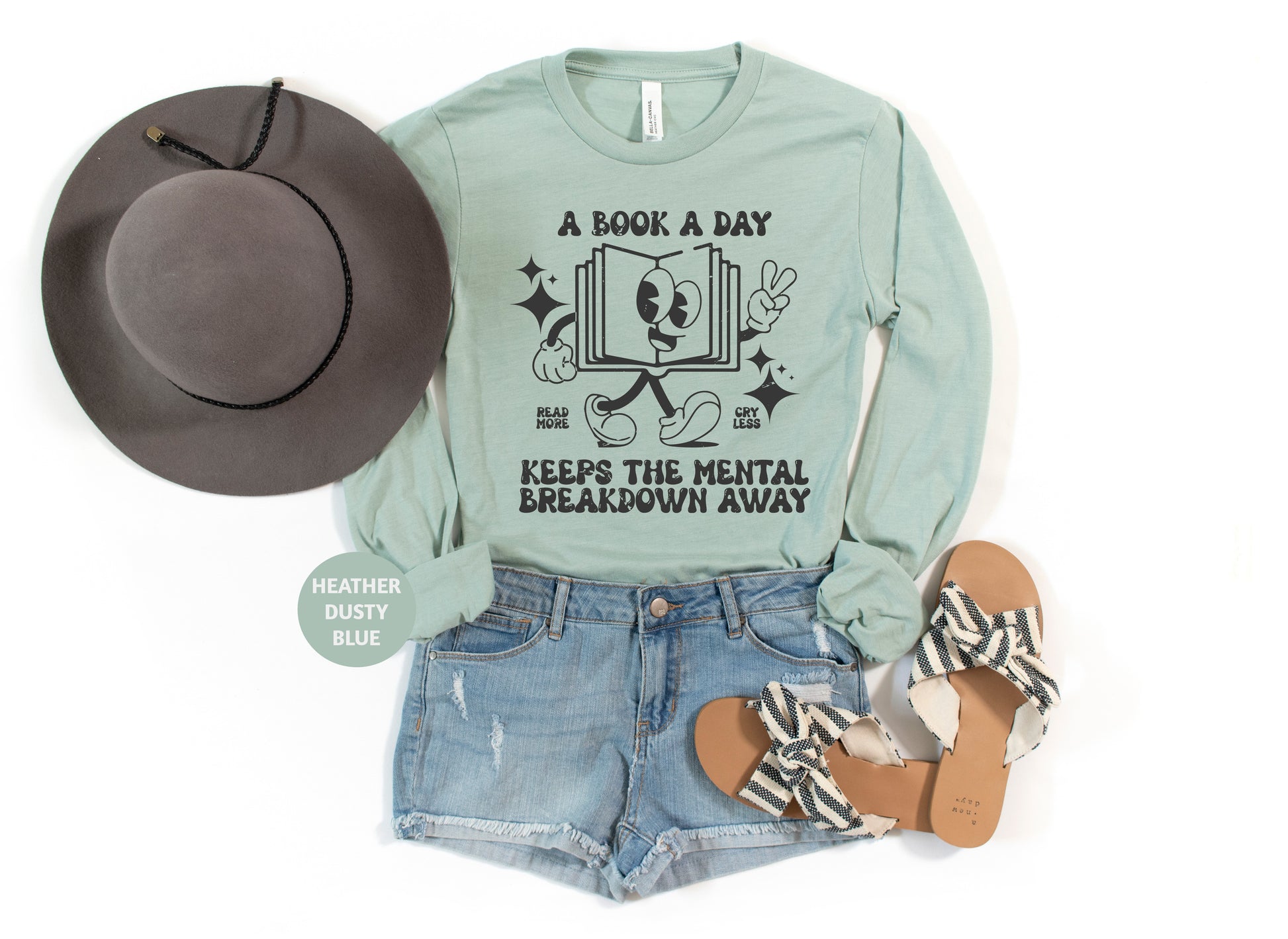a green shirt with a book and a hat