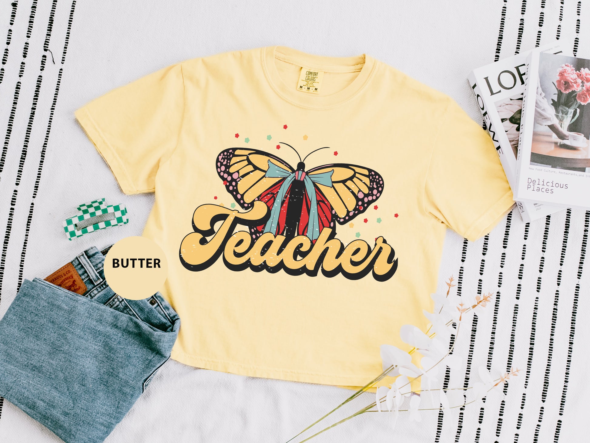 a yellow t - shirt with a butterfly on it