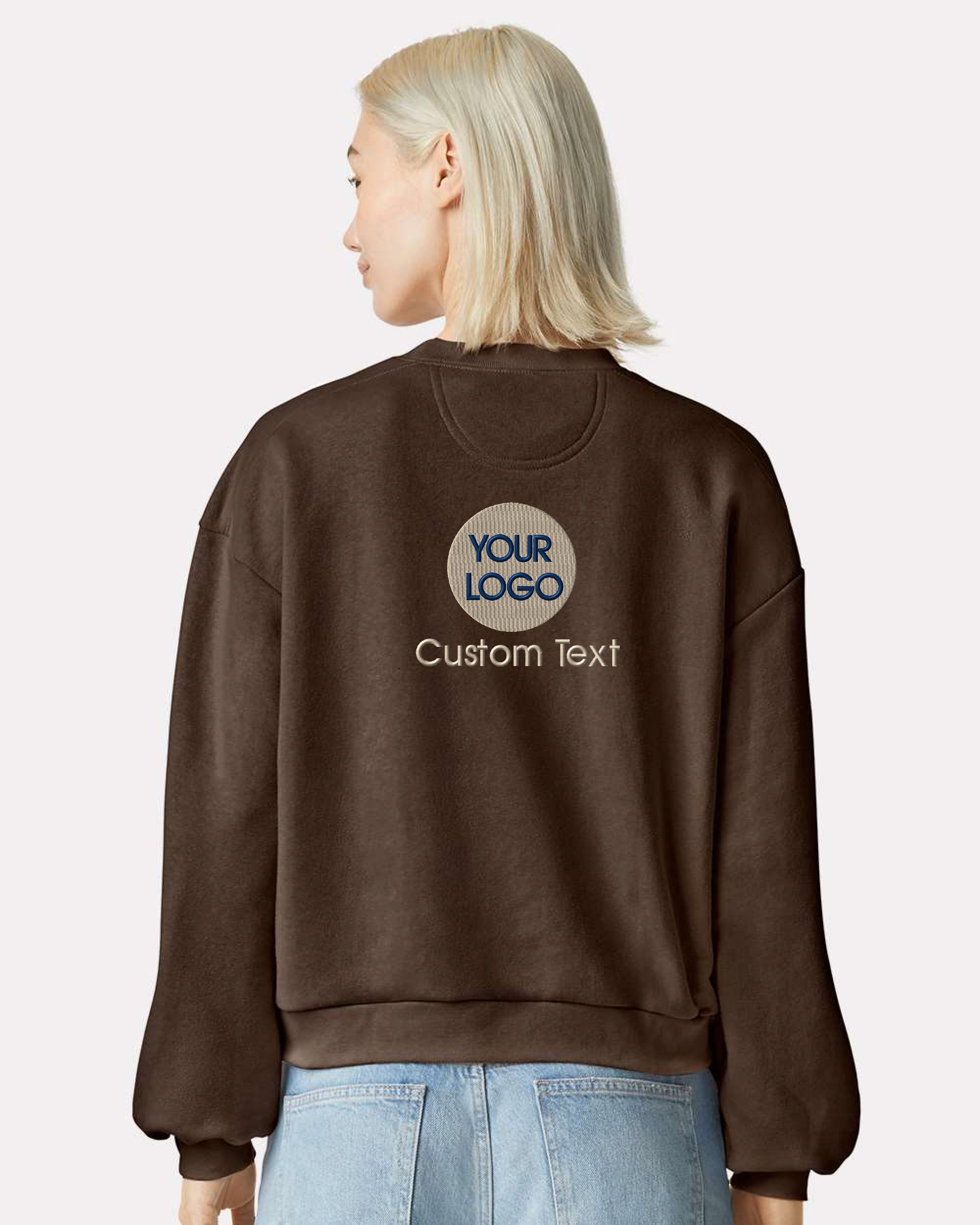 a woman with blonde hair wearing a brown sweatshirt