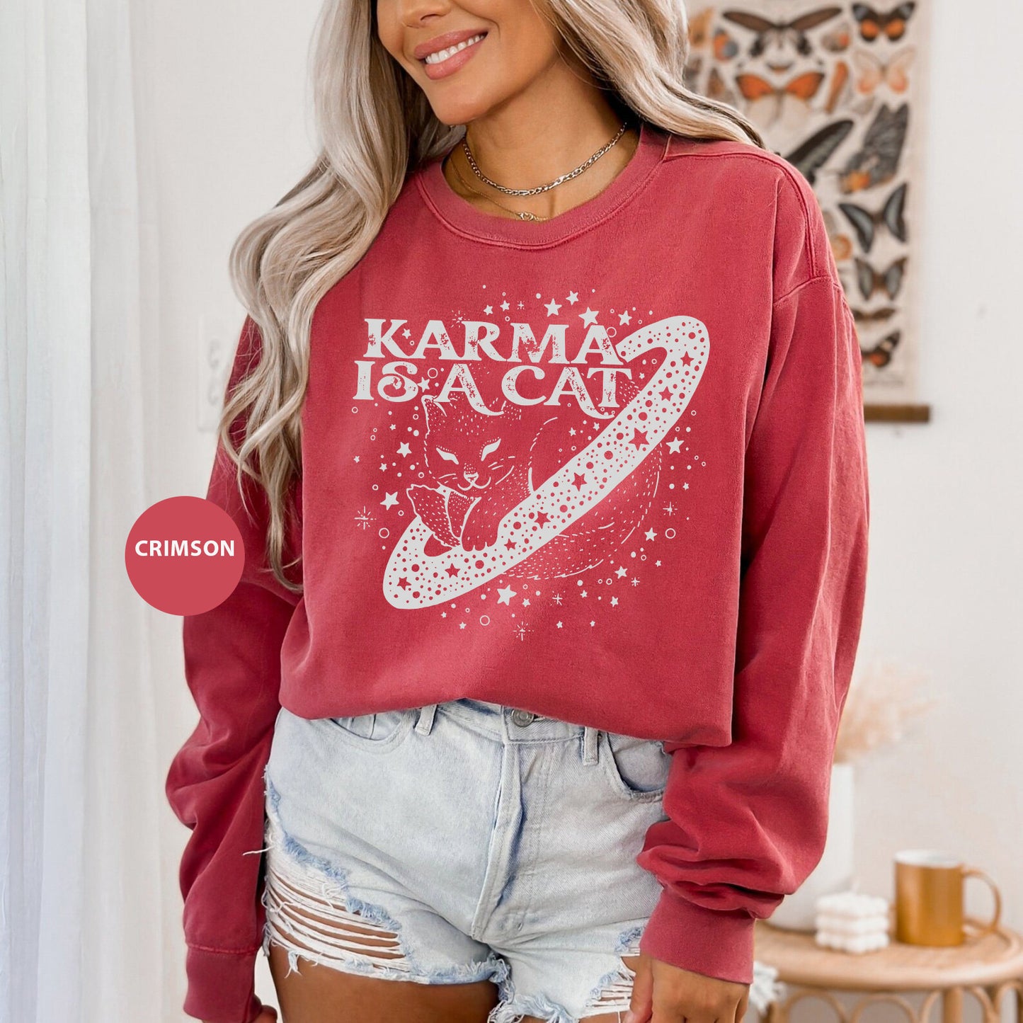 a woman wearing a red sweatshirt with a graphic on it