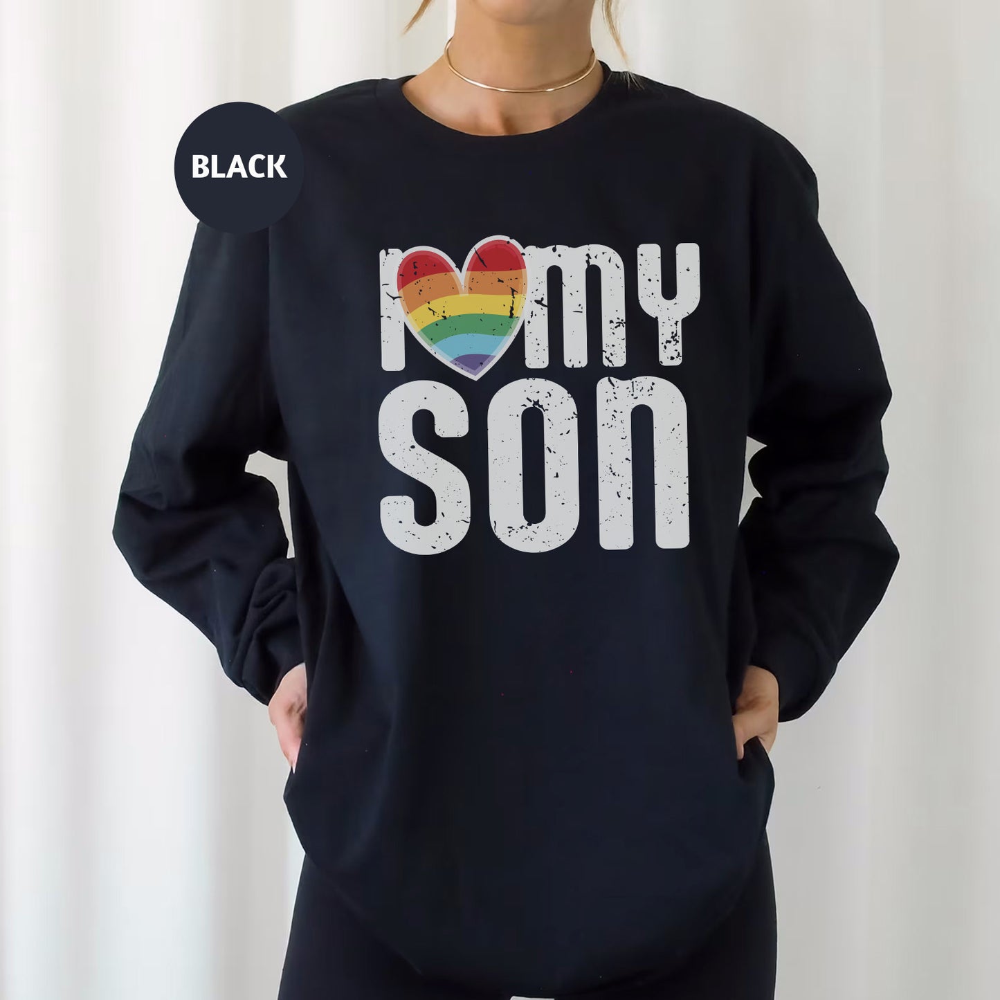 a woman wearing a black sweatshirt with the words i love my son printed on it
