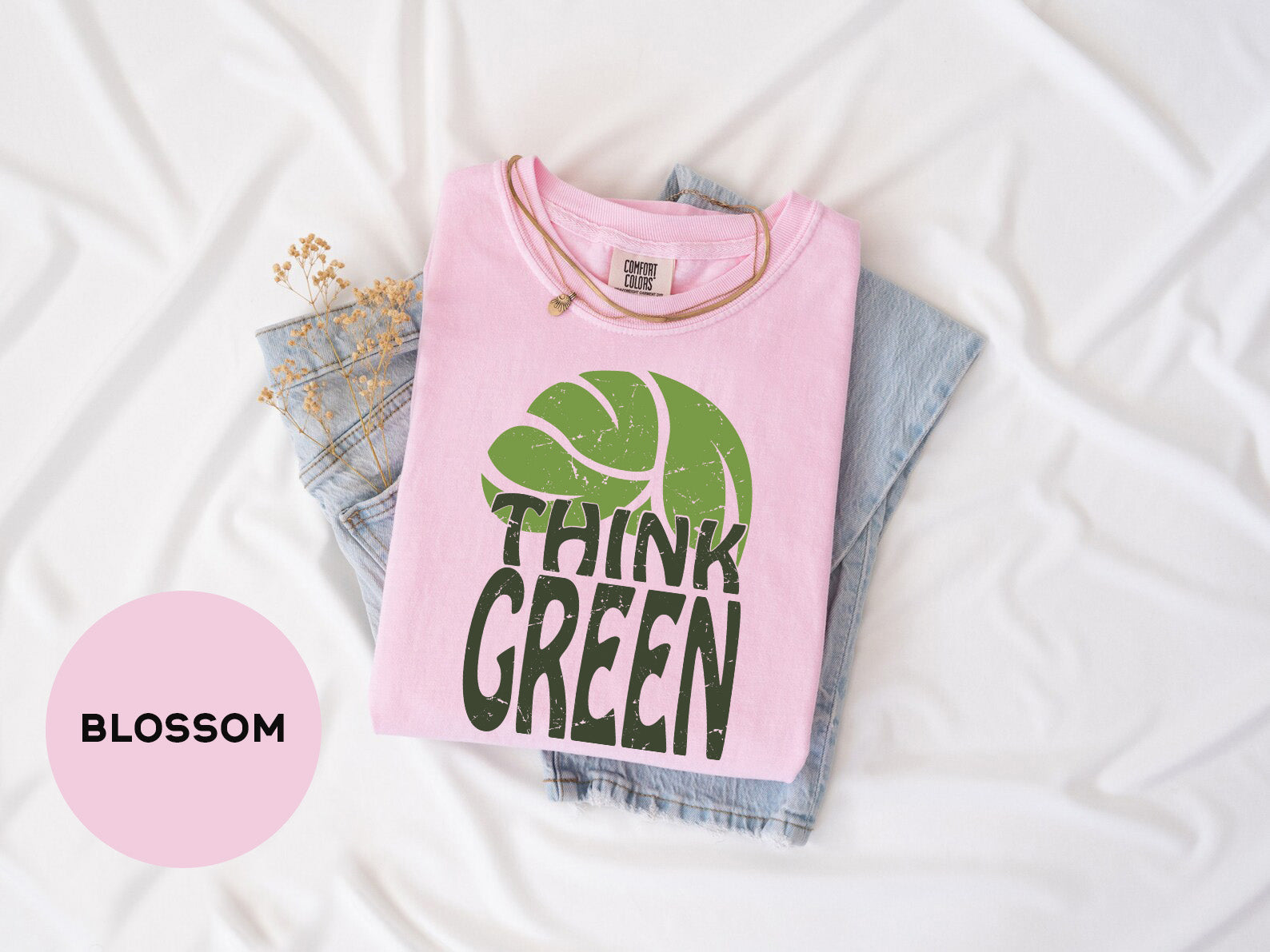 a pink shirt that says think green on it