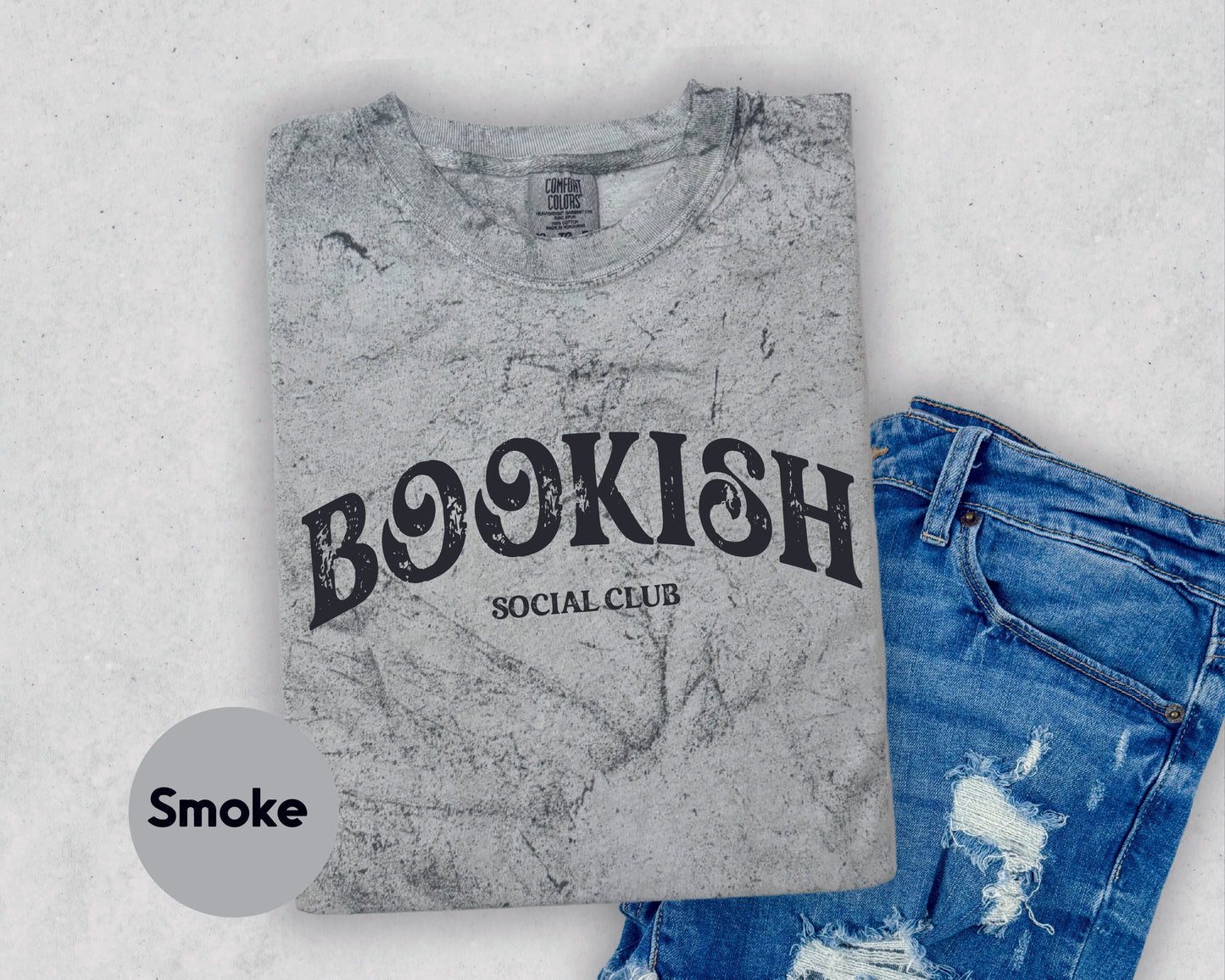 a t - shirt with the words bookish on it next to a pair of