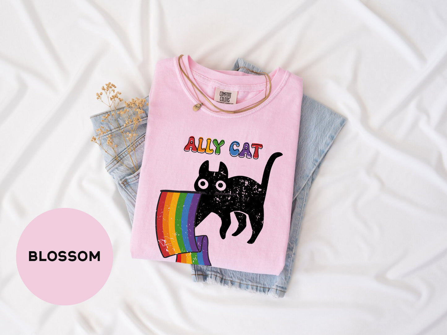 a pink shirt with a black cat on it