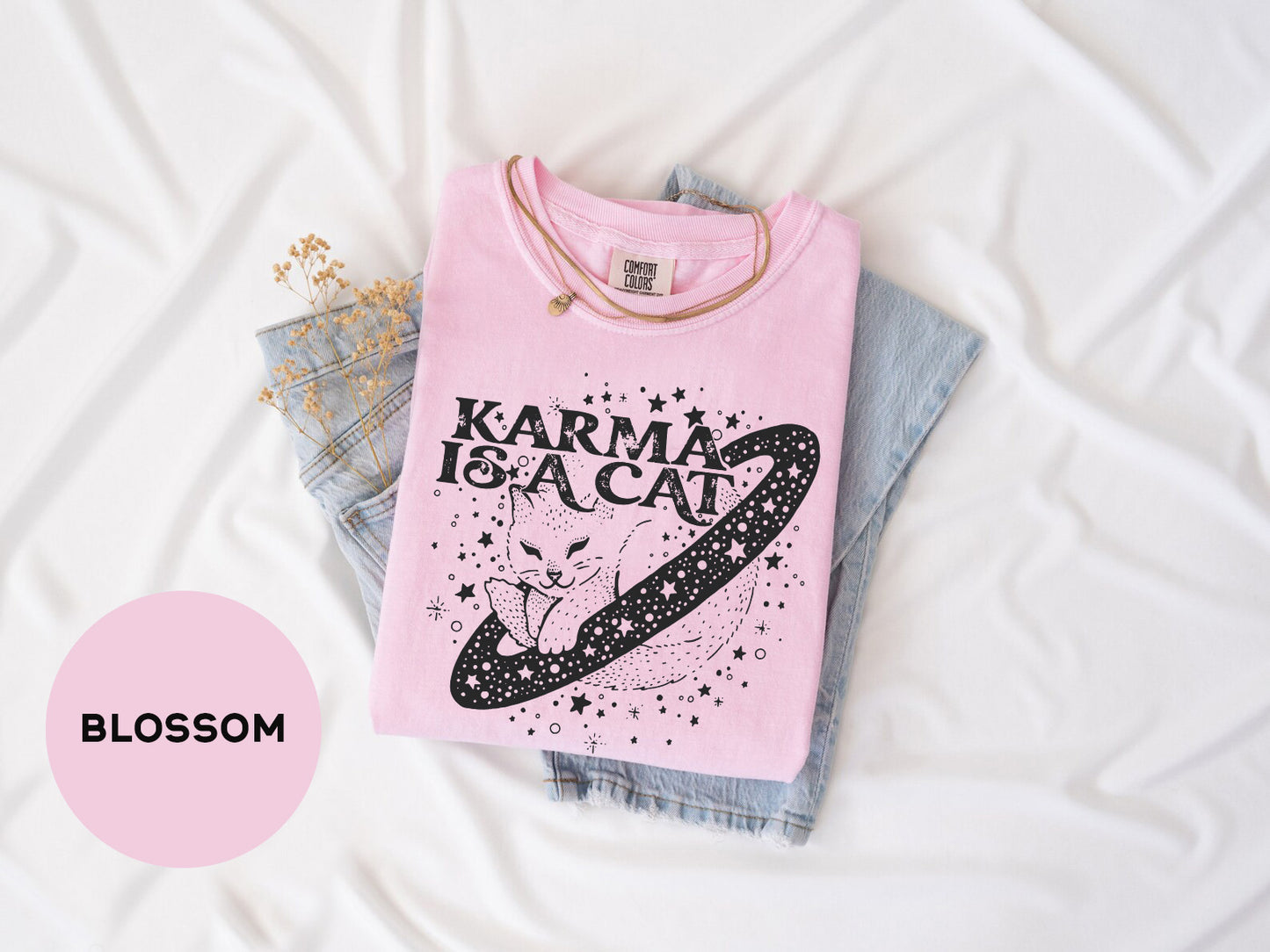 a pink t - shirt with the words karma is a cat on it