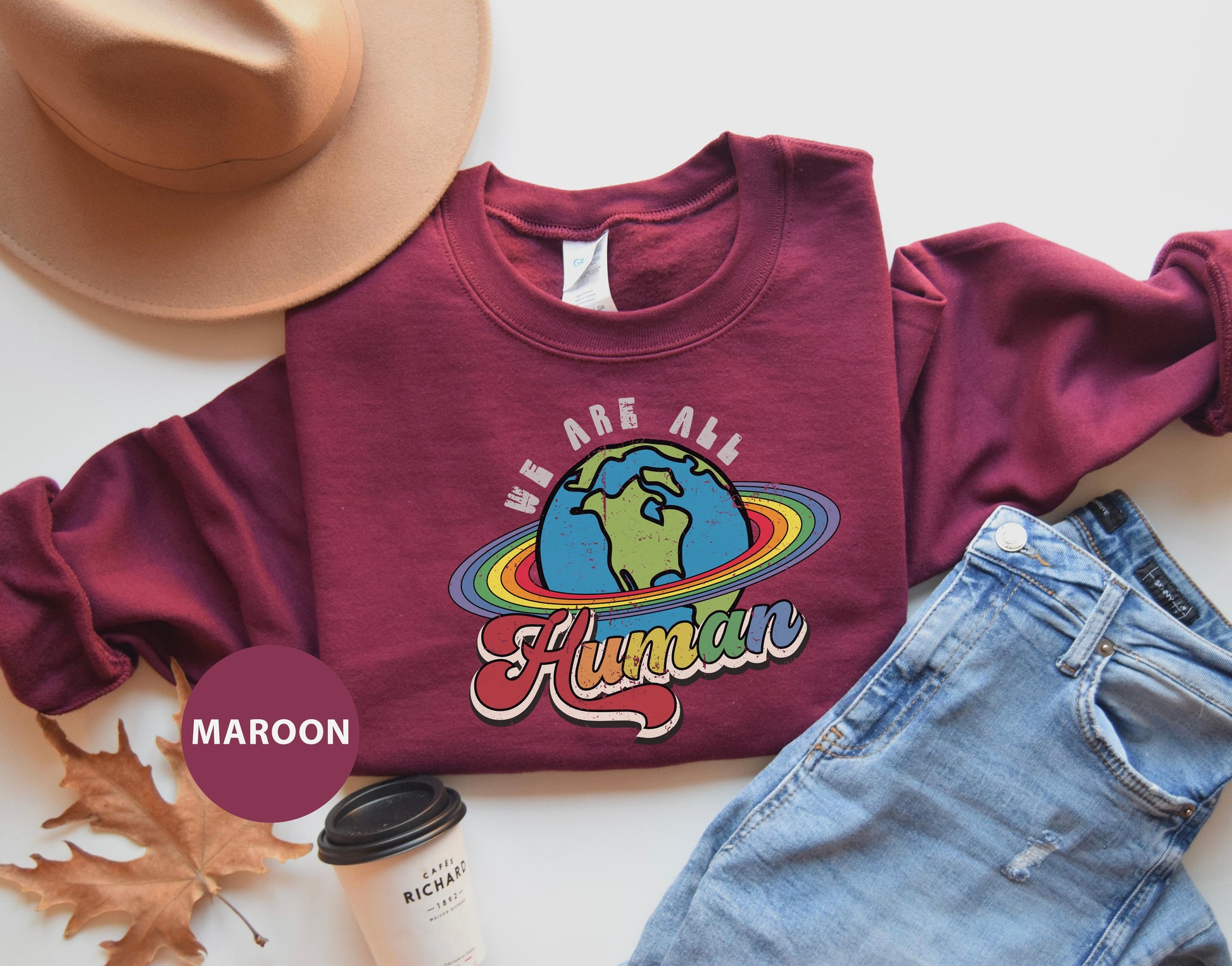 a pair of jeans, a hat, and a t - shirt on a table