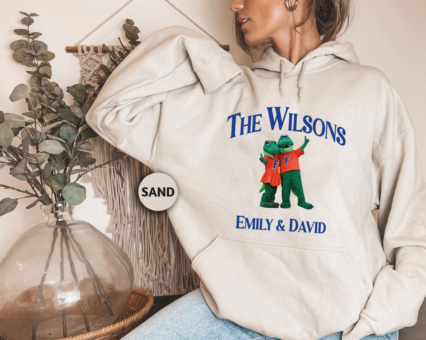a woman wearing a sweatshirt with the words the wilsons on it