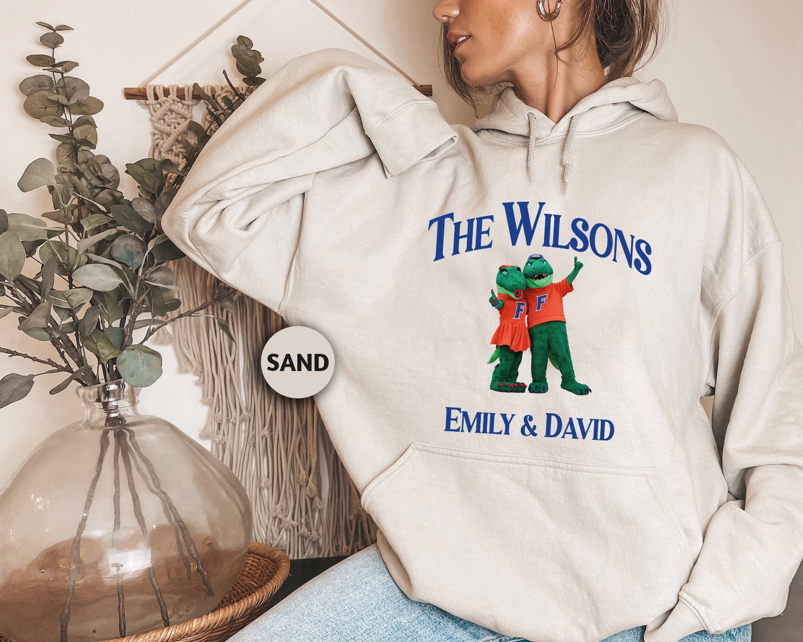 a woman wearing a sweatshirt with the words the wilsons on it