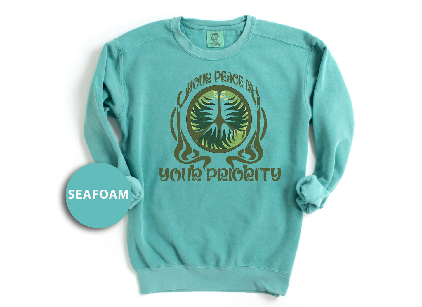 a blue sweatshirt with a green tree on it