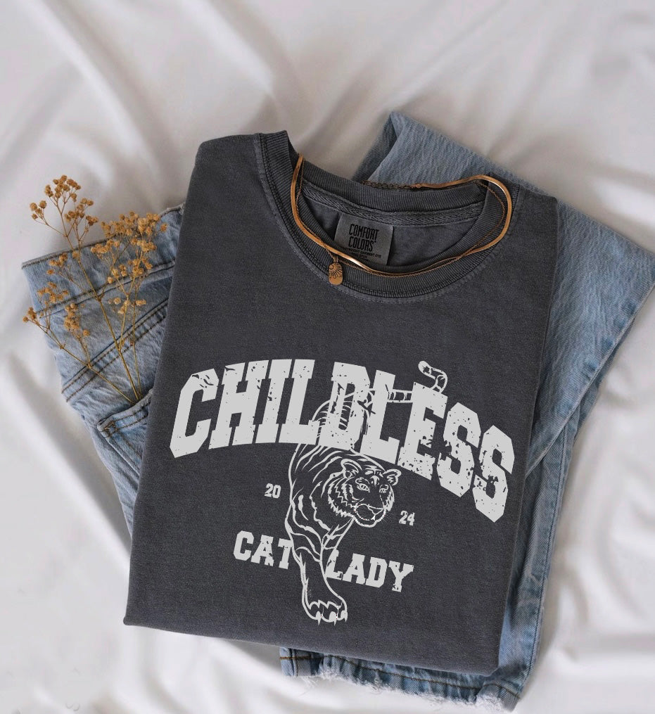 a t - shirt with a tiger on it sitting on top of a pair of