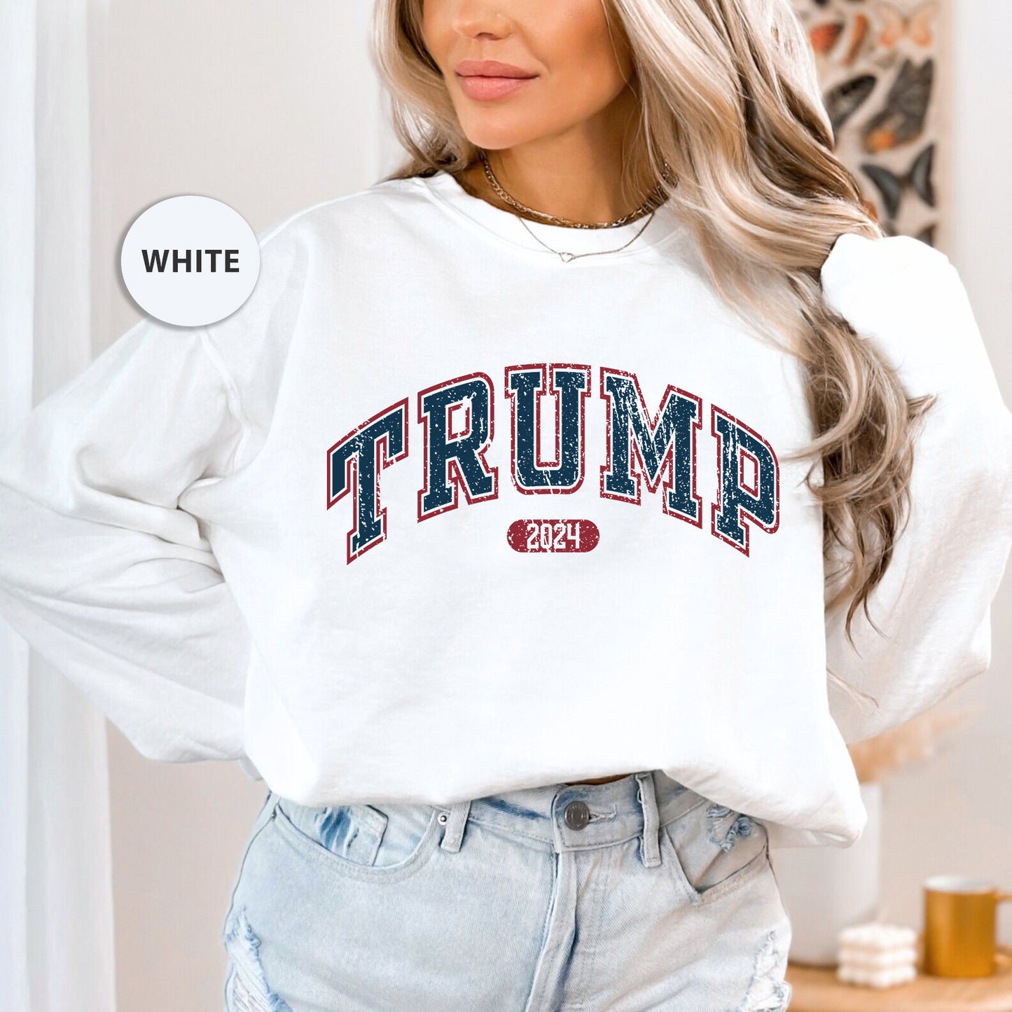a woman wearing a white sweatshirt with the word trump printed on it