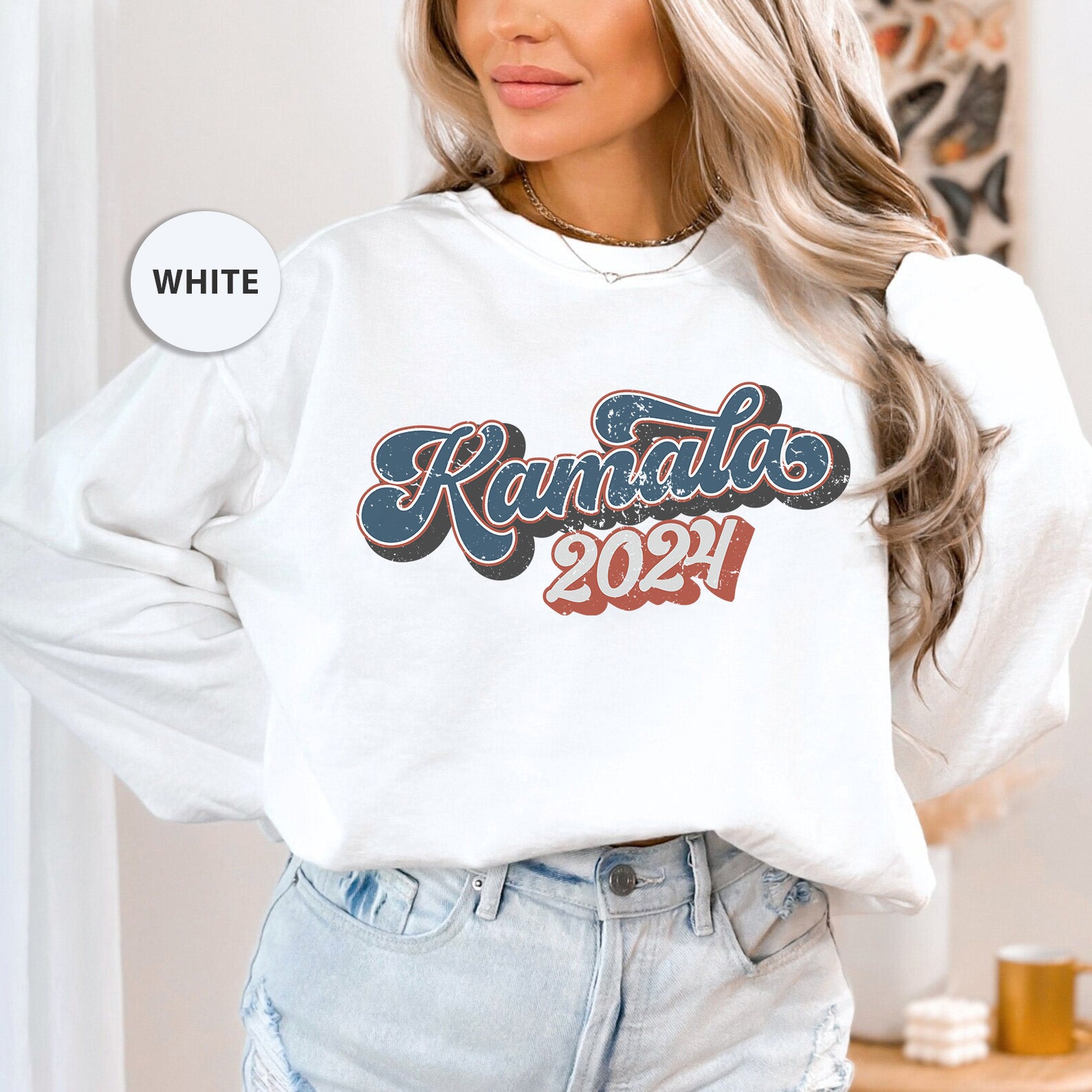 a woman wearing a white sweatshirt and jeans