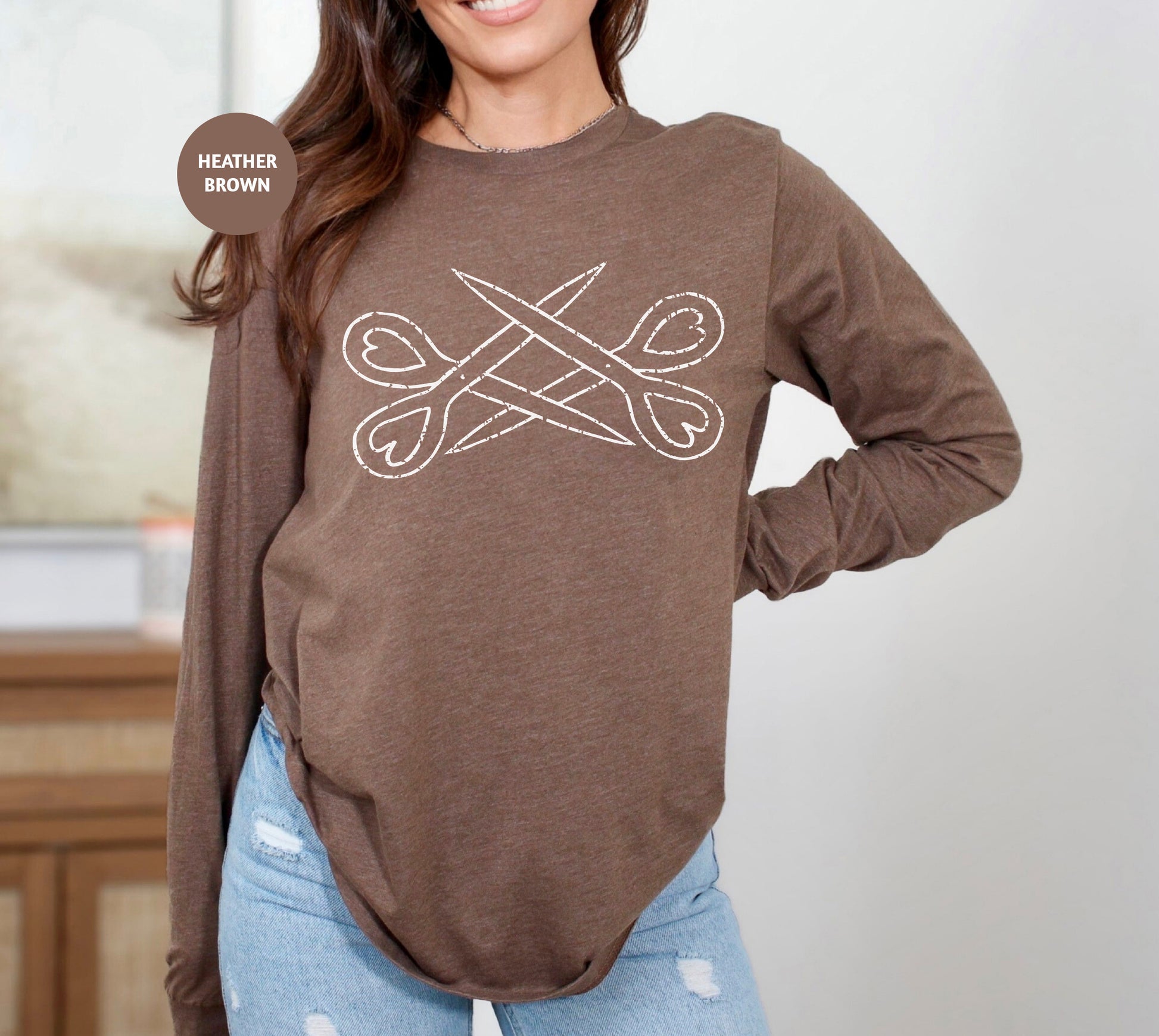 a woman wearing a brown shirt with scissors on it