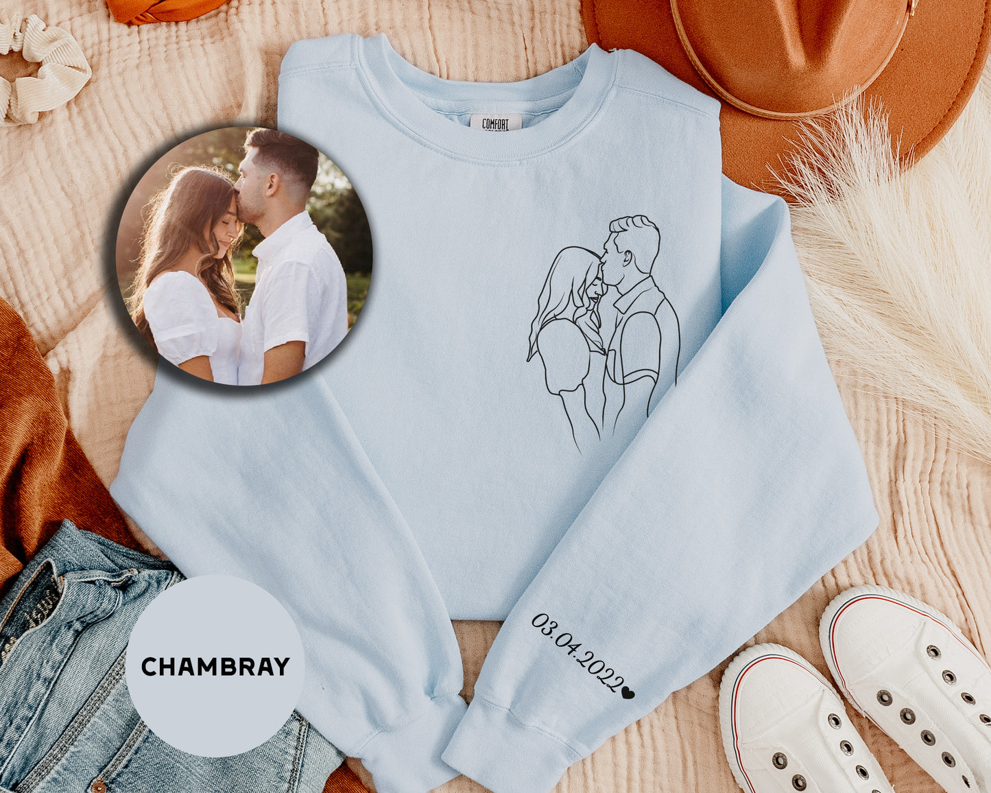 a photo of a couple on a blue sweatshirt next to a pair of white shoes