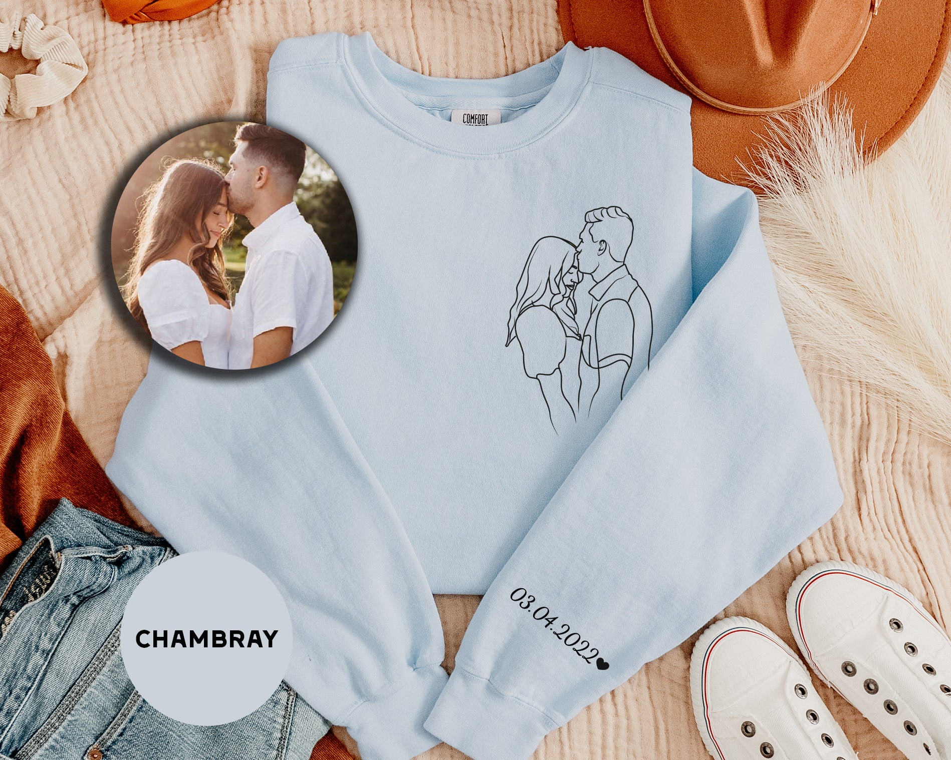 a photo of a couple on a blue sweatshirt next to a pair of white shoes