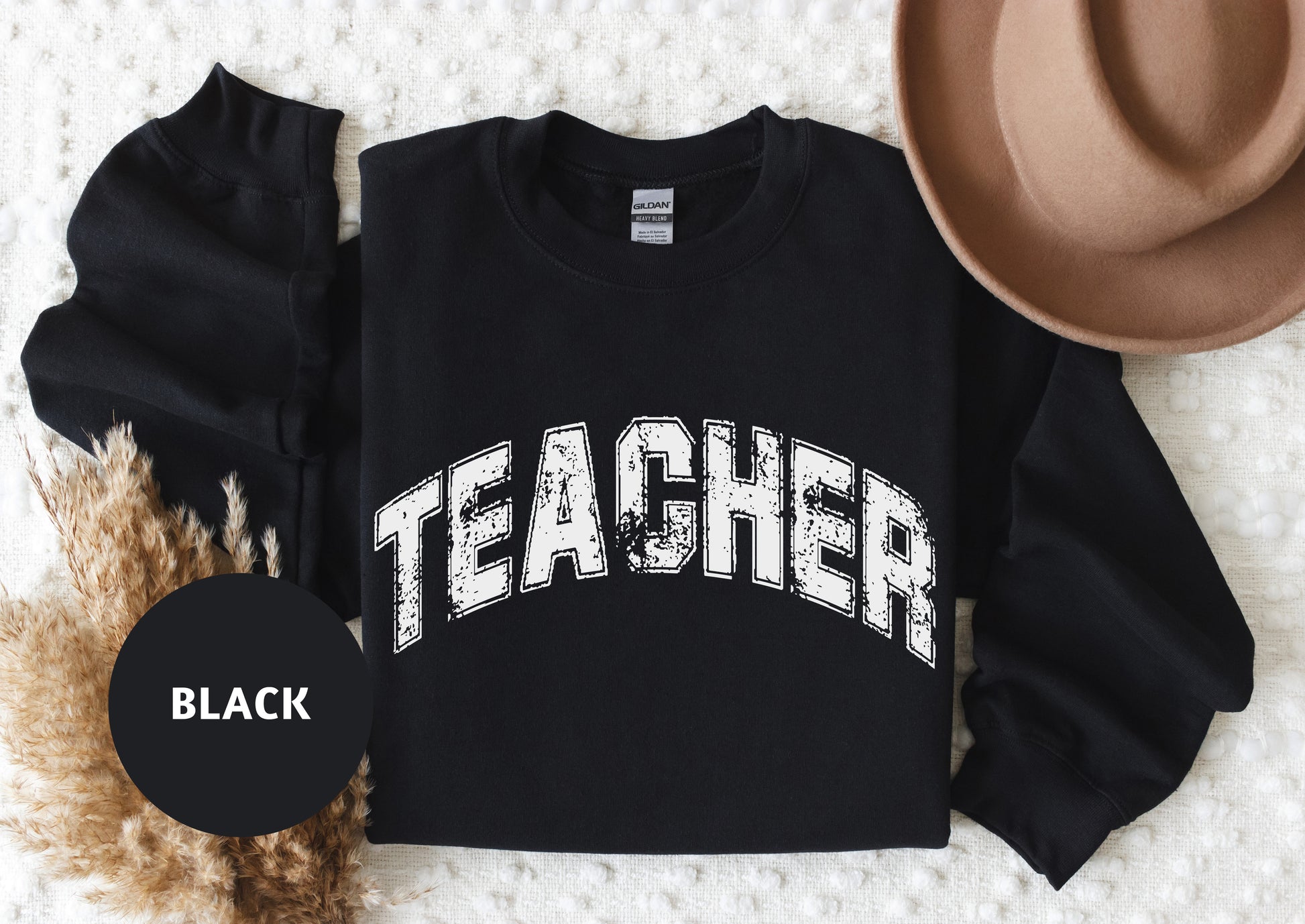 a black sweatshirt with the word teacher printed on it