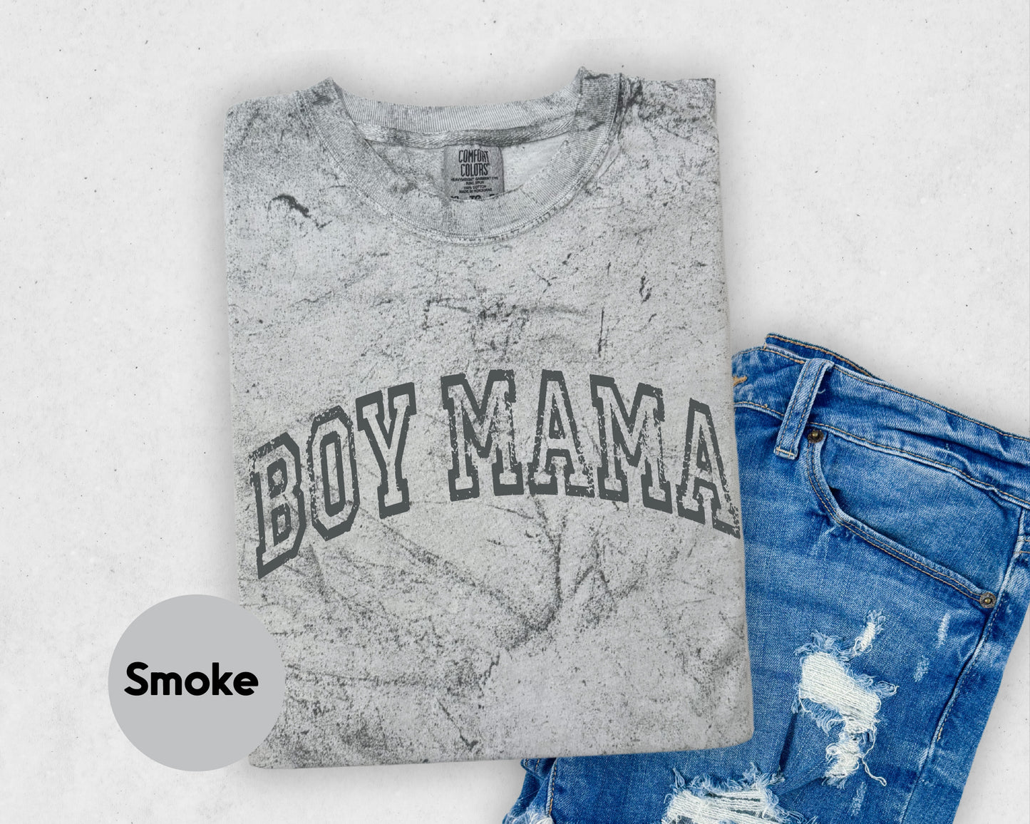 a t - shirt with the word boy mama on it next to a pair of