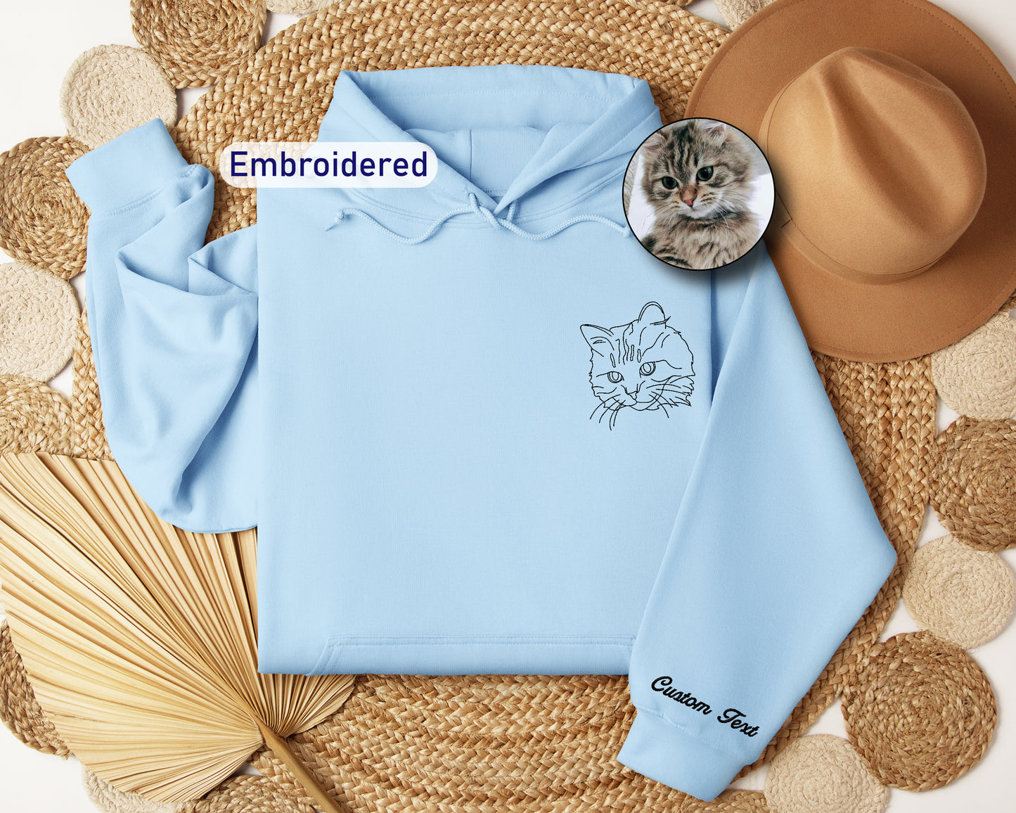 a blue hoodie with a picture of a cat on it