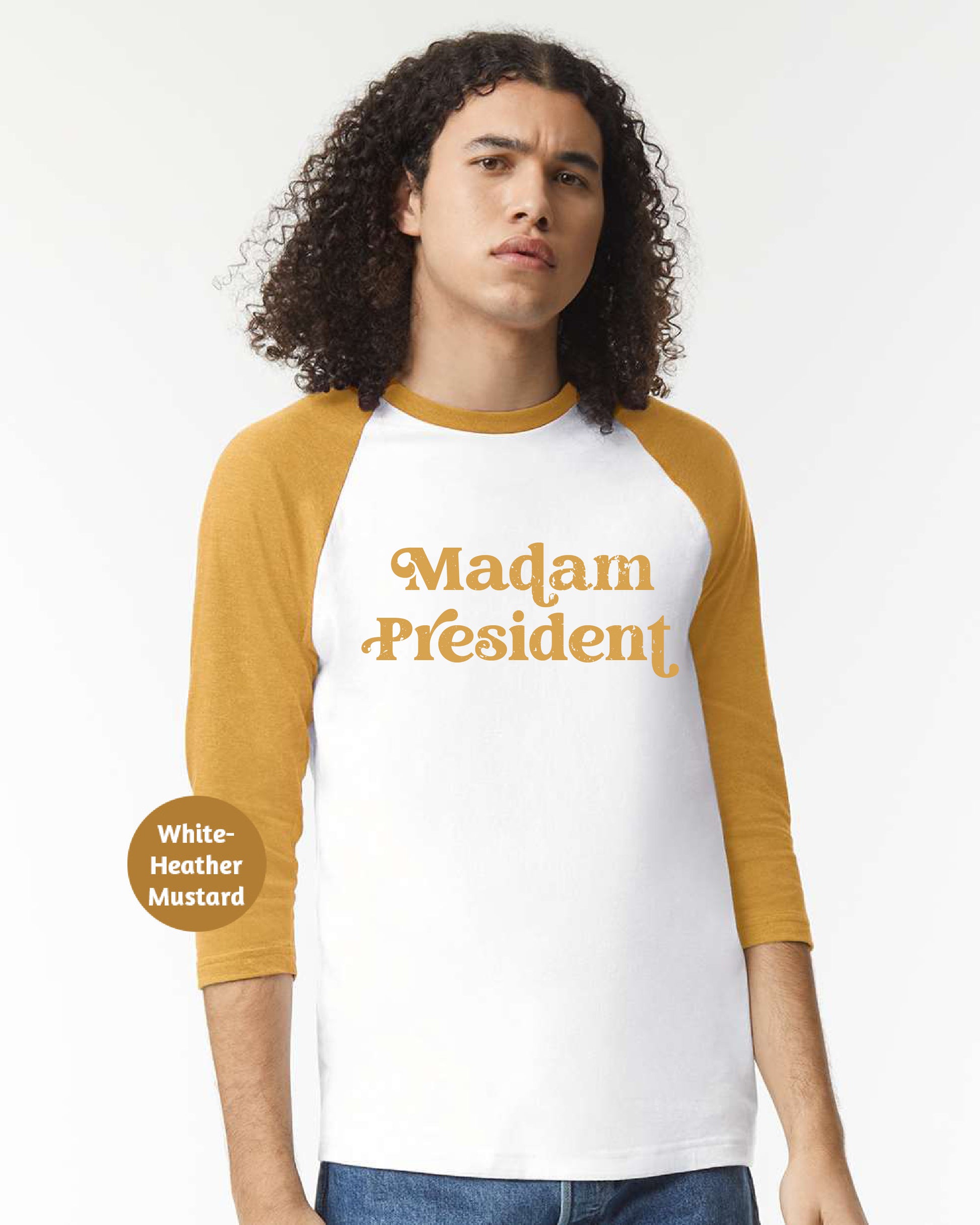 a man with long curly hair wearing a white and yellow shirt