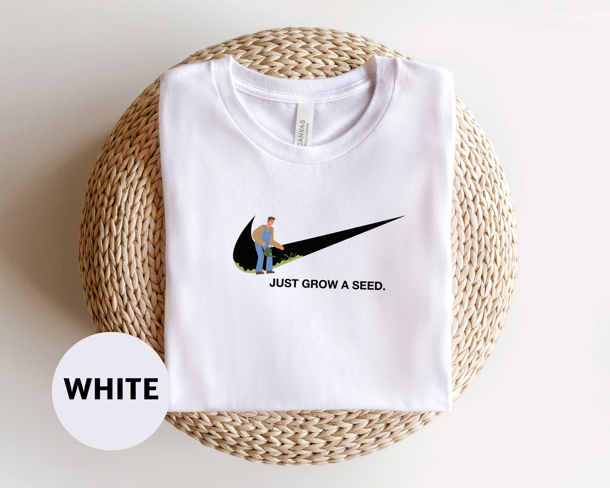 a white t - shirt with a picture of a man sitting on a black nike