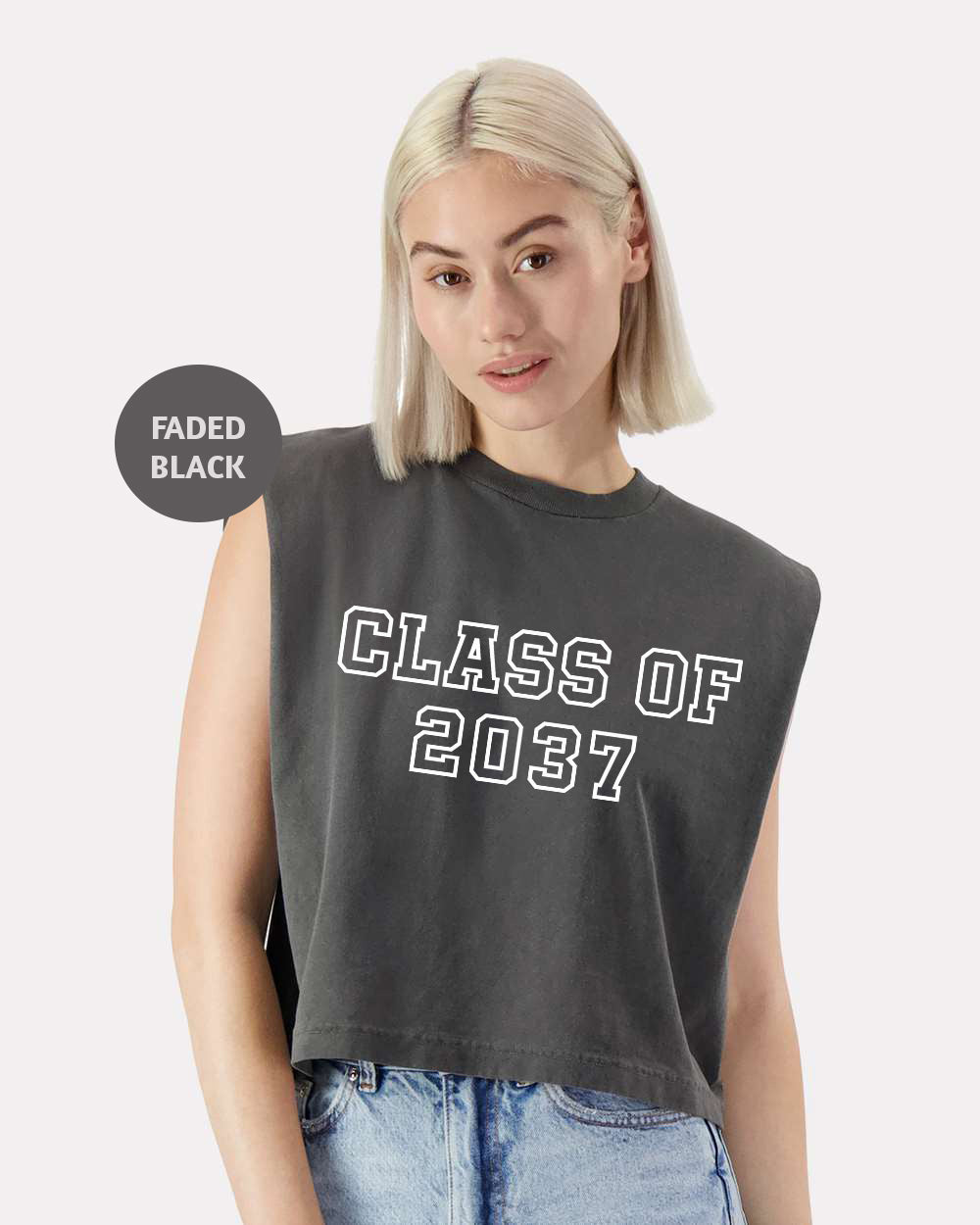 a woman with blonde hair wearing a black class of 2021 crop top