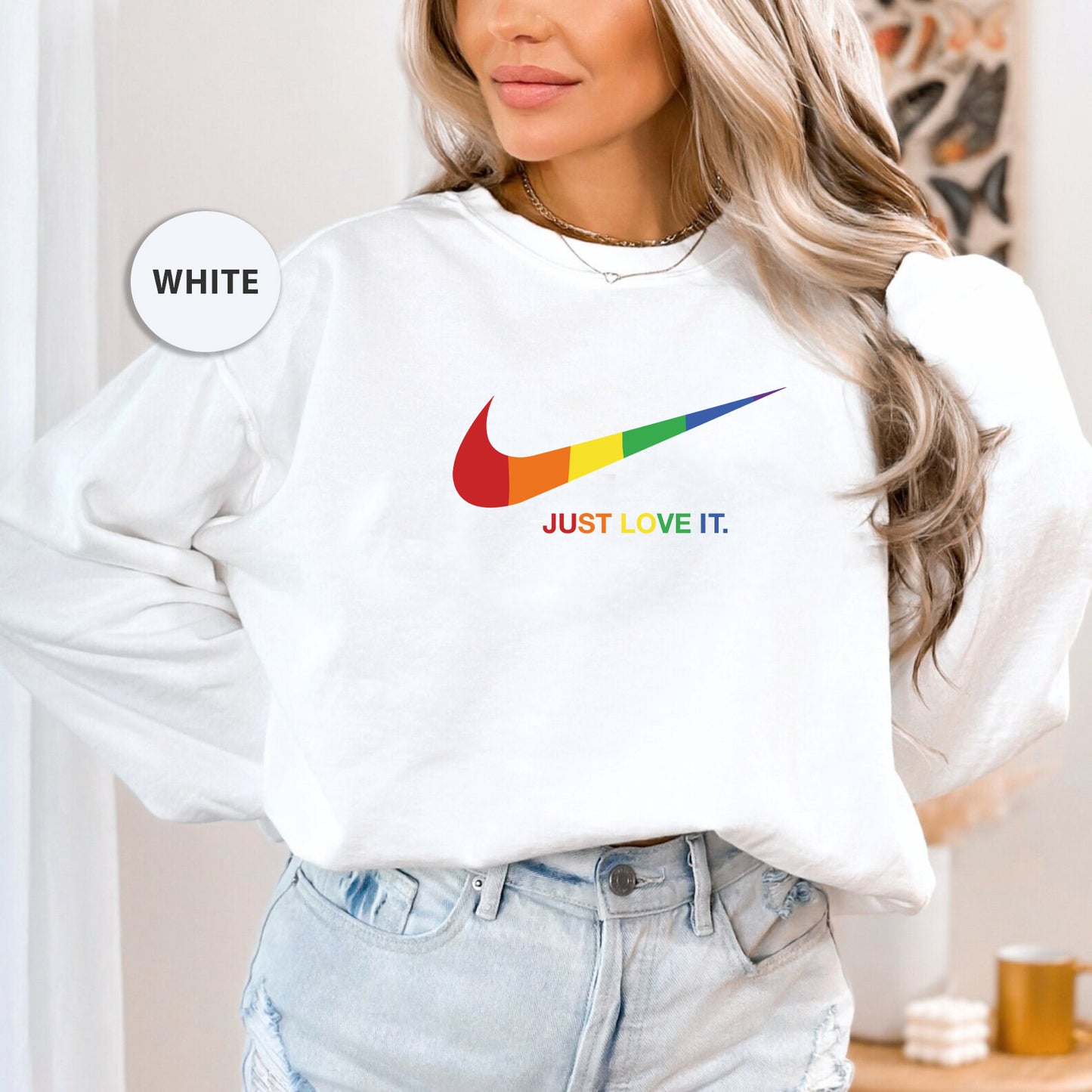 a woman wearing a white nike sweatshirt and jeans