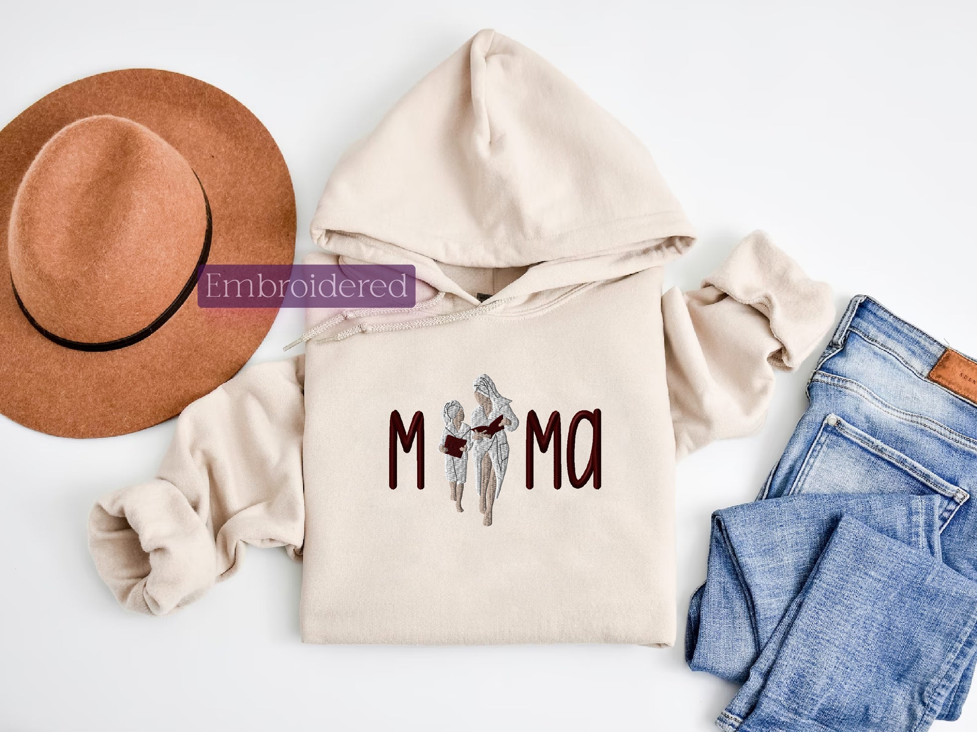 a hat, jeans, and sweatshirt with the word mom written on it