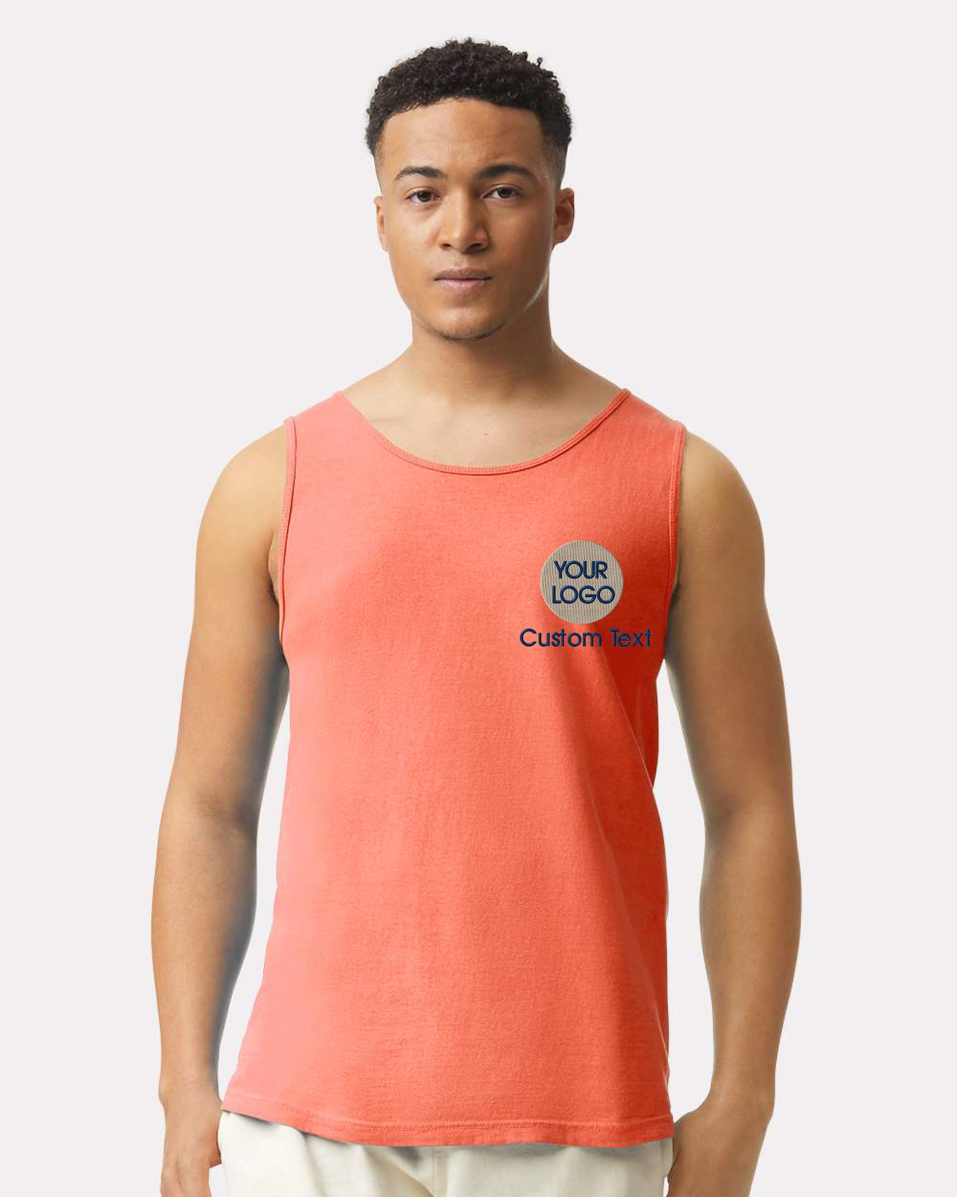 a man in an orange tank top is posing for a picture