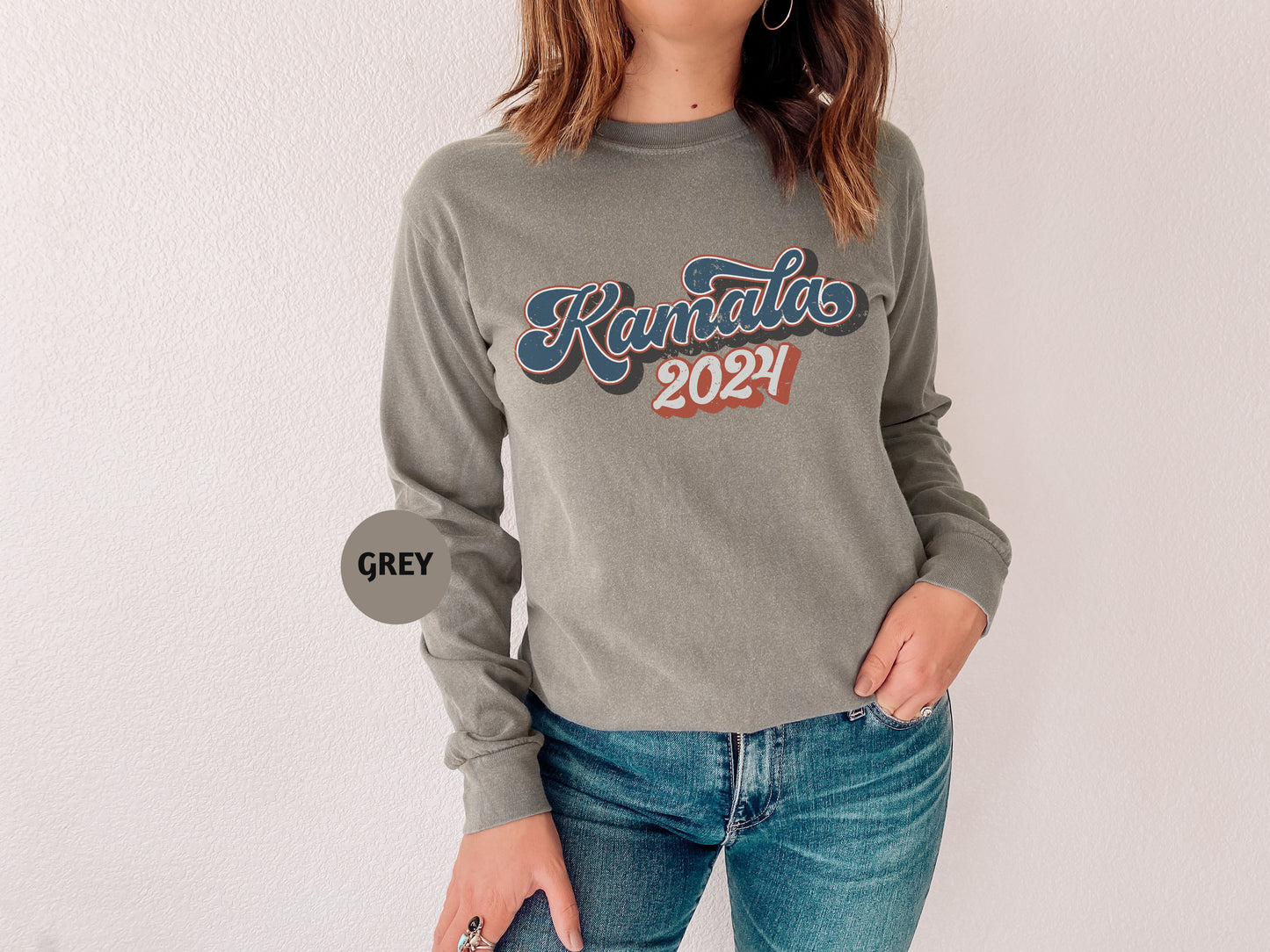 a woman wearing a kansas sweatshirt and jeans