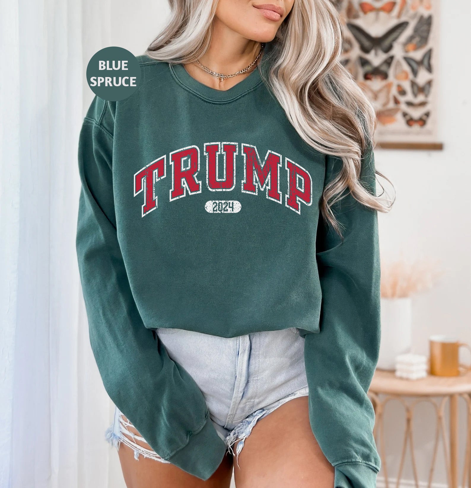 a woman wearing a green sweatshirt with the word trump on it