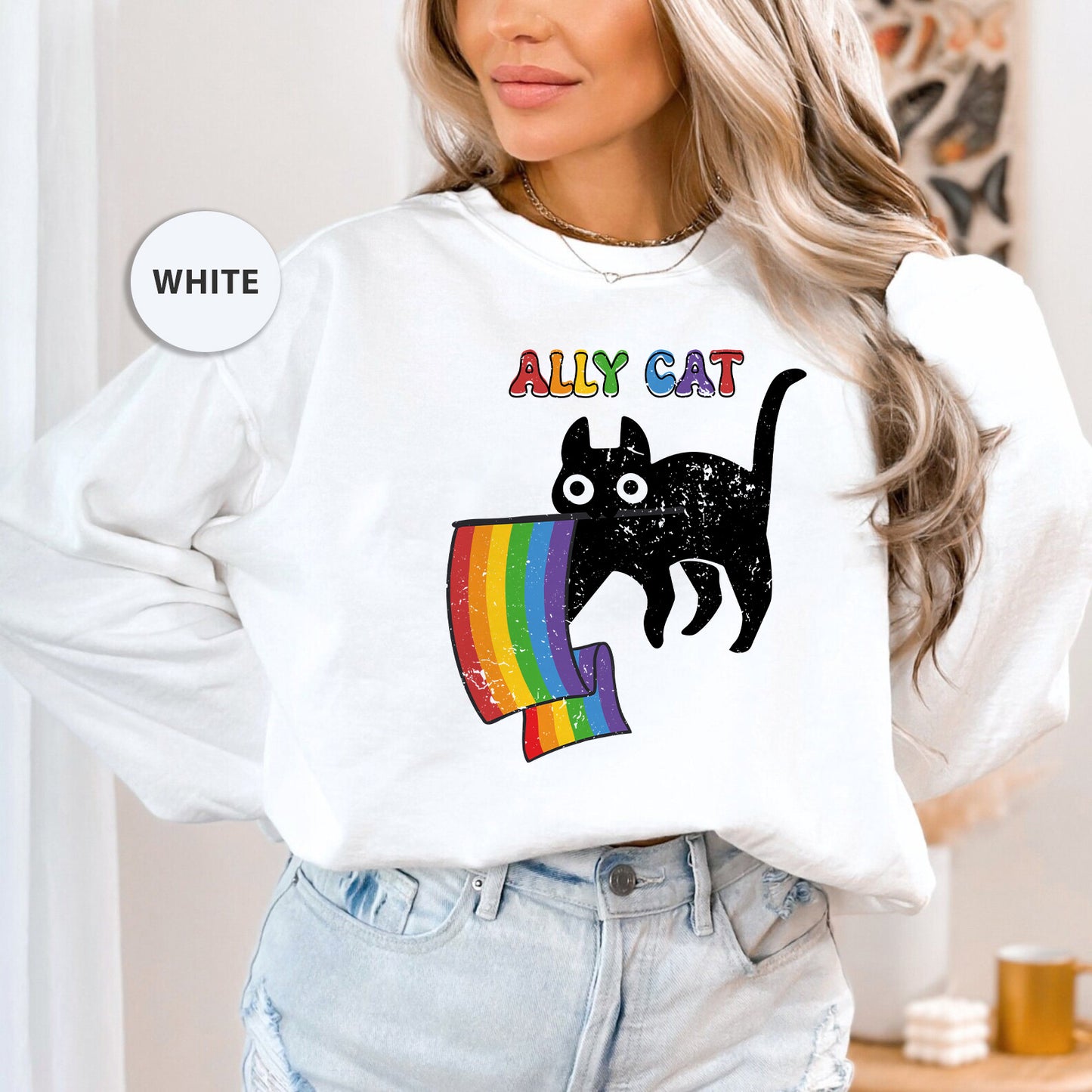 a woman wearing a white sweatshirt with a black cat on it