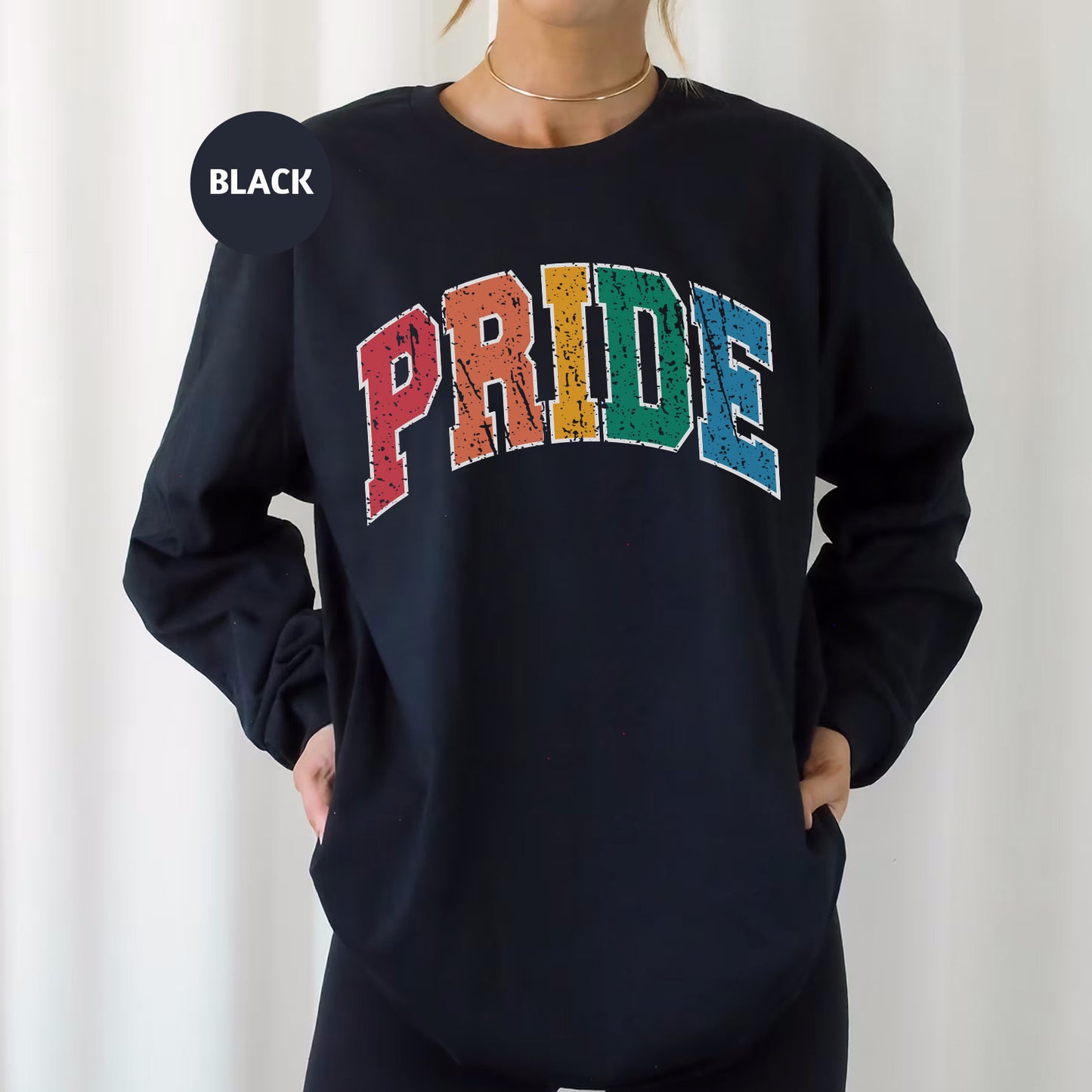 a woman wearing a black sweatshirt with the word pride printed on it