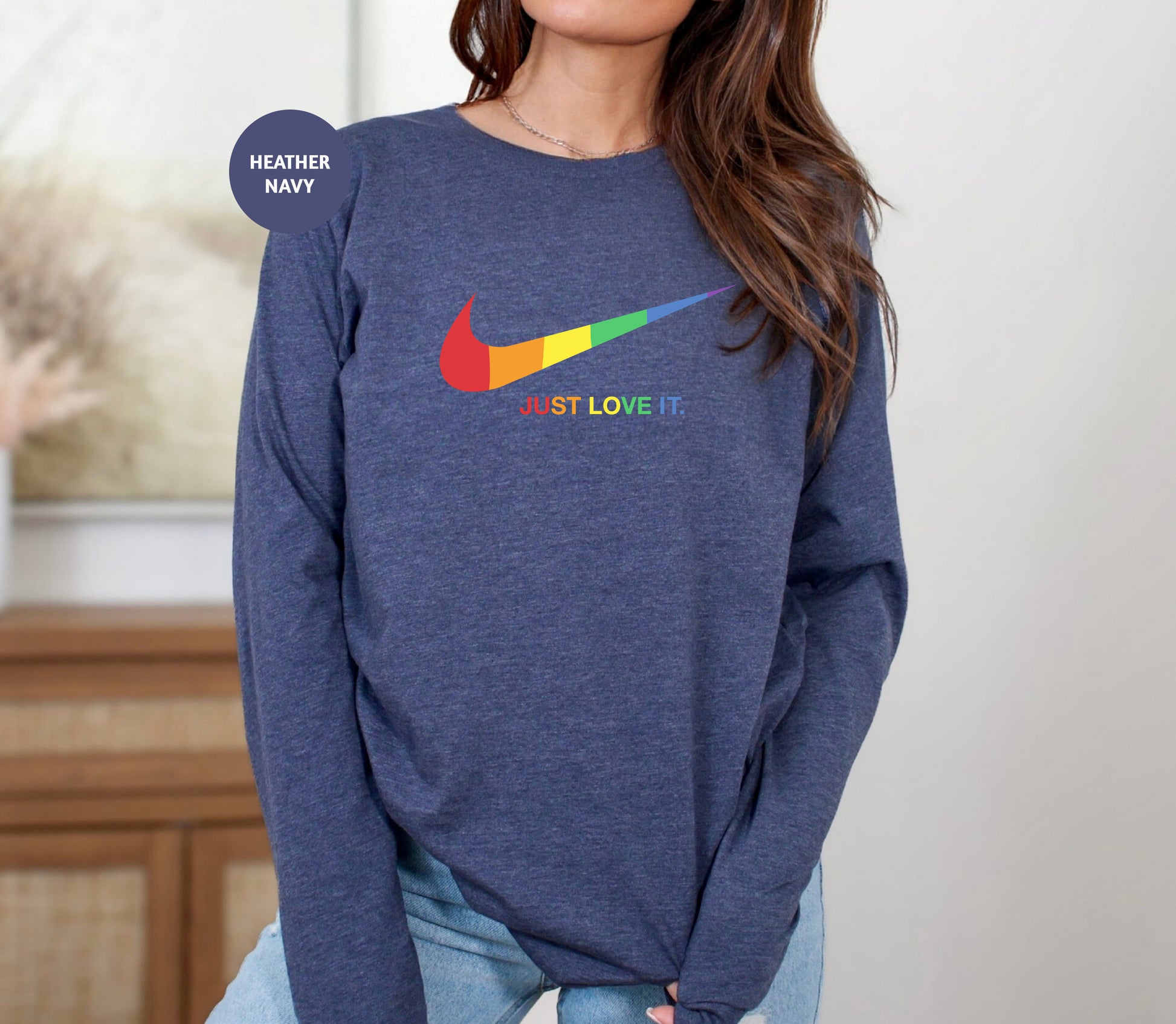 a woman wearing a blue sweatshirt with a colorful nike logo on it