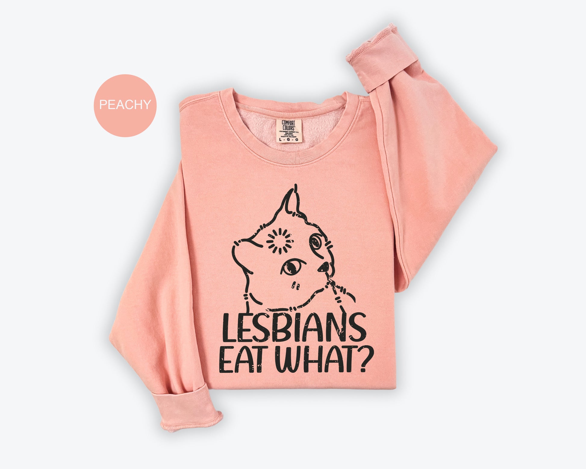 a pink shirt with a picture of a cat that says lesbians eat what?