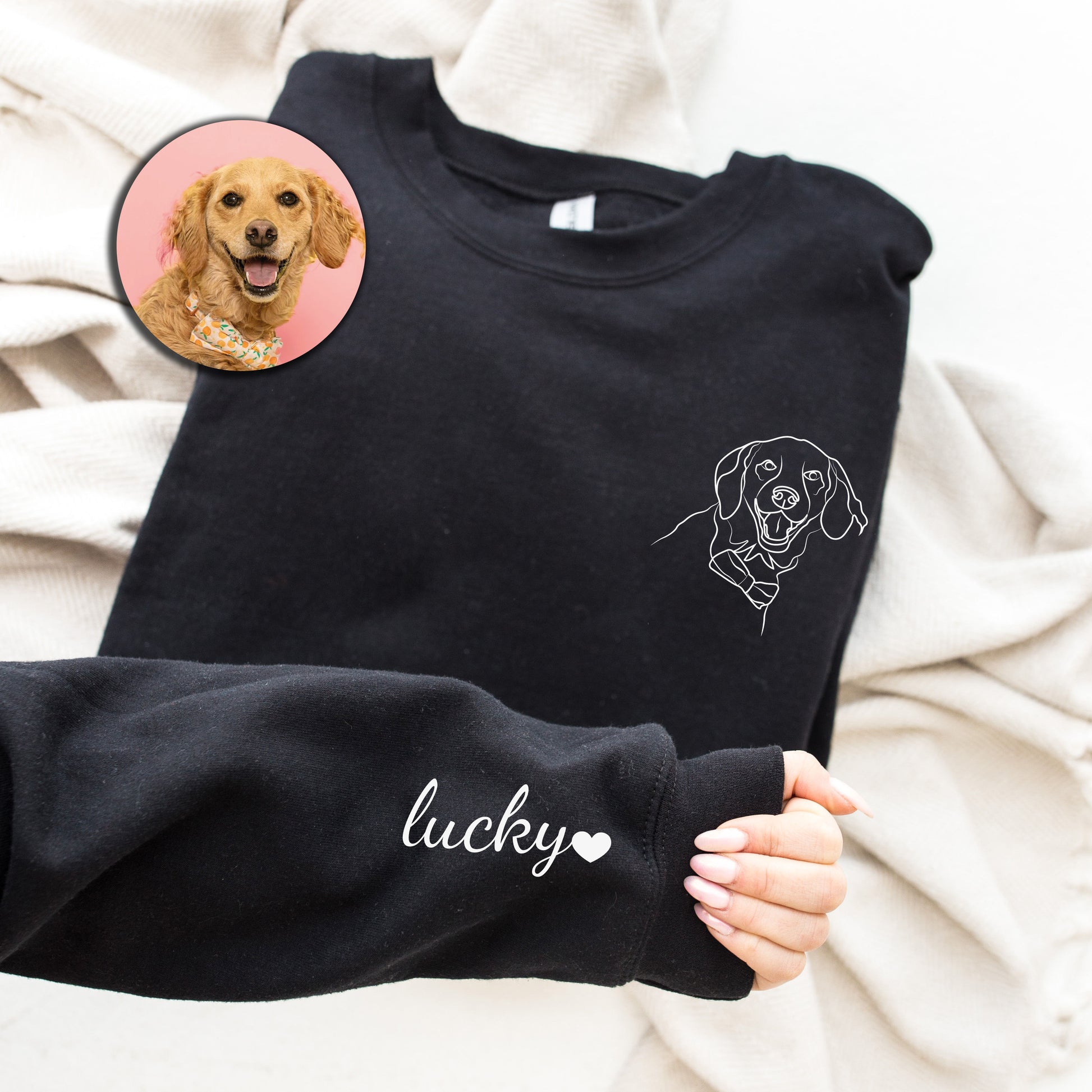 a person holding a dog sweater with a picture of a dog on it